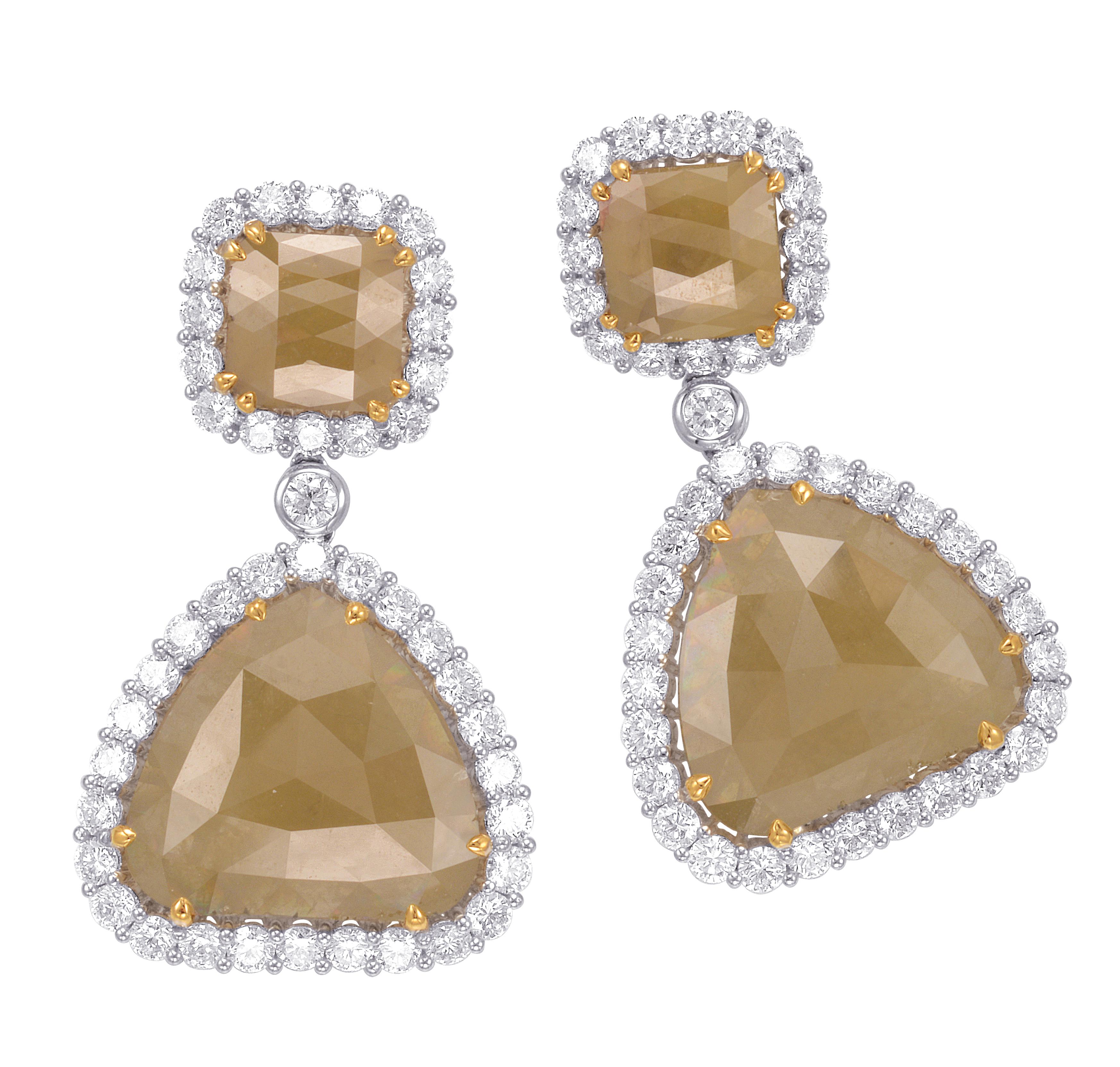 These stunning earrings feature 2 Rose Cut Natural (unheated) Fancy Yellow Diamonds, total of 32.52 carats, encircled in a single halo of round brilliant Diamonds (20 x 22mm).

They are hanging from 2 Emerald Cut Natural Fancy Yellow Diamonds, total