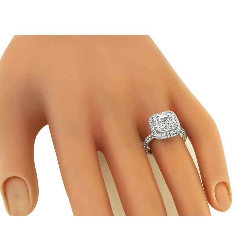 This is a stunning 14k white gold engagement ring. The ring is centered with a sparkling GIA certified emerald cut diamond that weighs 4.01ct. The color of the diamond is H with VVS2 clarity. The center diamond is accentuated by small round cut