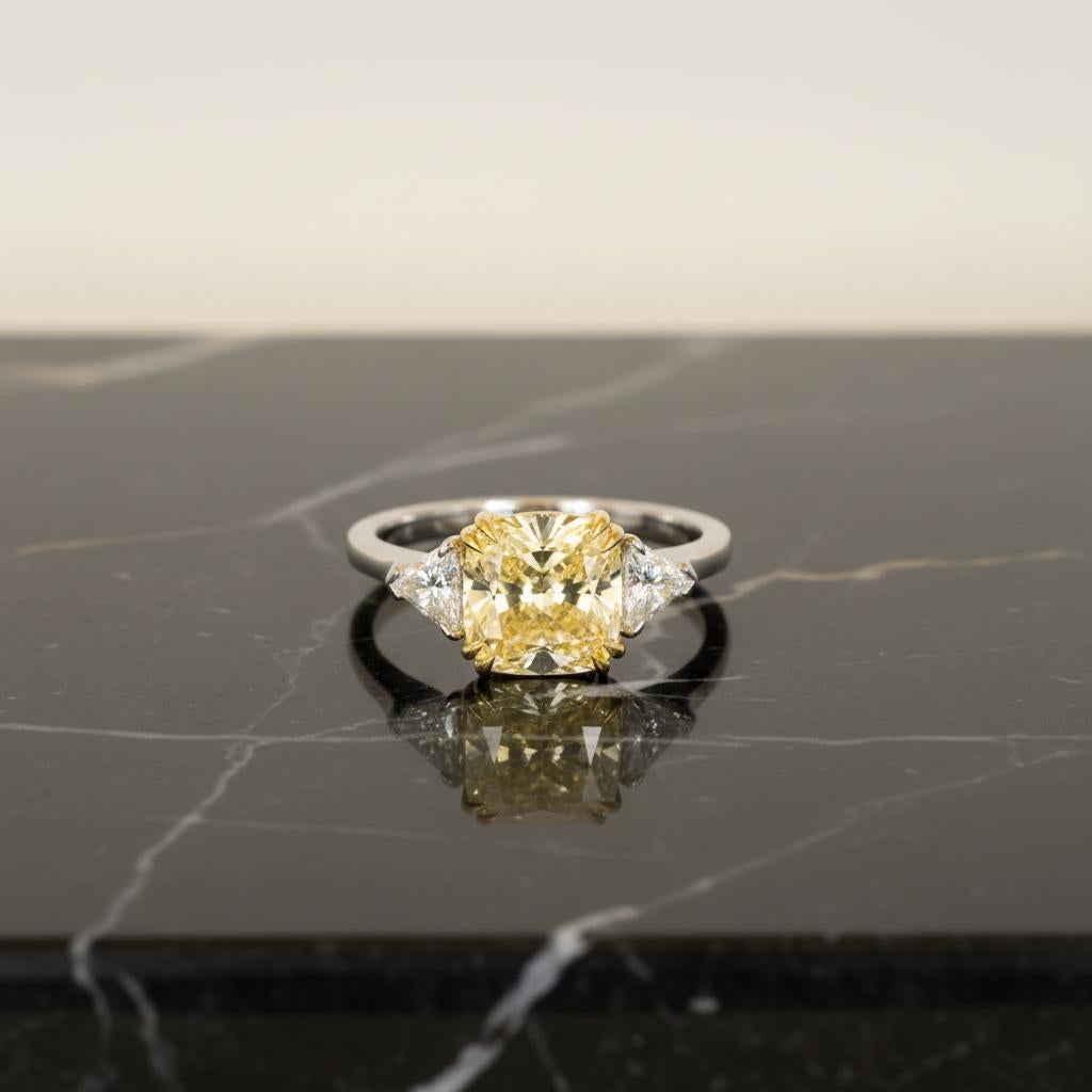 Cette bague exquise met en valeur un diamant coussin modifié de 4,02 carats certifié par le GIA, de couleur jaune fantaisie, présentant une brillance et une saturation exceptionnelles.
Le diamant est classé VS2, avec un excellent poli, une bonne