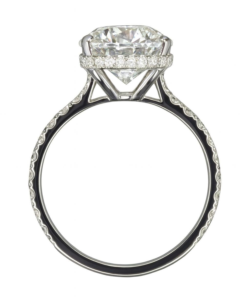 This elegant 4 carat oval cut diamond ring is a stunning blend of beauty and craftsmanship, designed to captivate and inspire. Set in 18K white gold, the ring is further enhanced by a pavé diamond band, adding a touch of sparkle and sophistication