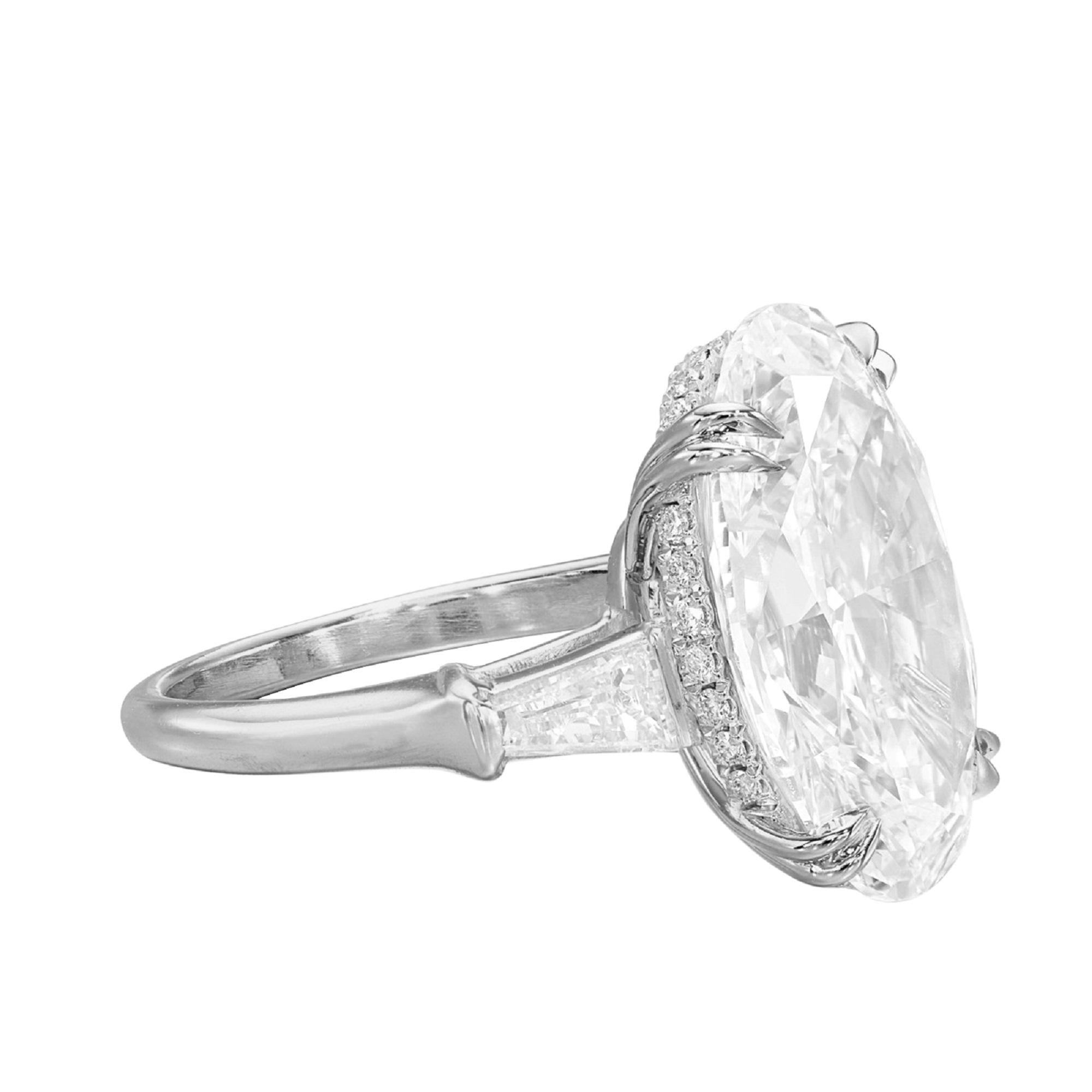 This engagement ring is a true epitome of elegance and brilliance. It is centered around a breathtaking 4-carat oval diamond, which is not only GIA certified but also boasts a G color rating and a VS1 clarity, ensuring its exceptional quality and