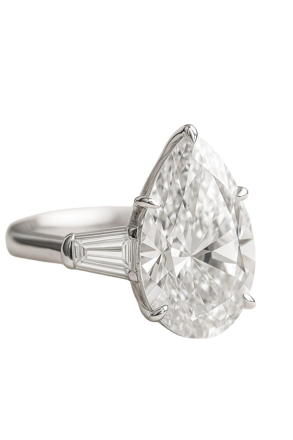 This exquisite platinum ring features a breathtaking 4.02-carat pear-shaped diamond, graded F color and Internally Flawless by GIA. The center stone is securely held by five refined platinum prongs that delicately frame its elegant silhouette,