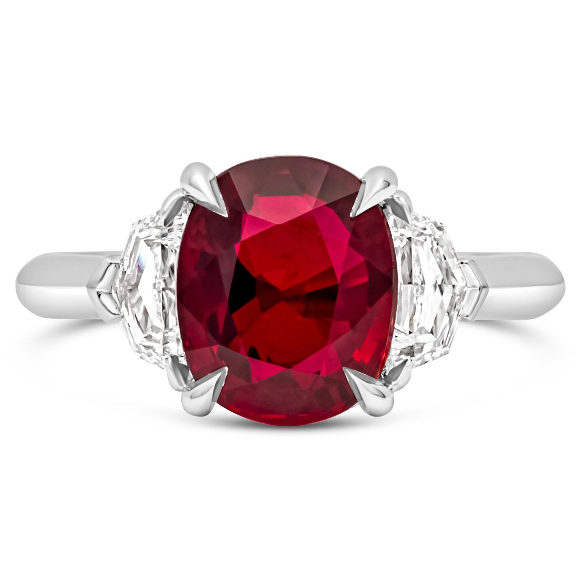 A wonderful and classy three stone engagement ring, showcasing a GIA certified 4.02 carats cushion brilliant cut ruby in the center, set on a four prong basket setting. Flanked by one diamond on each side weighing 0.50 carat total with F color and