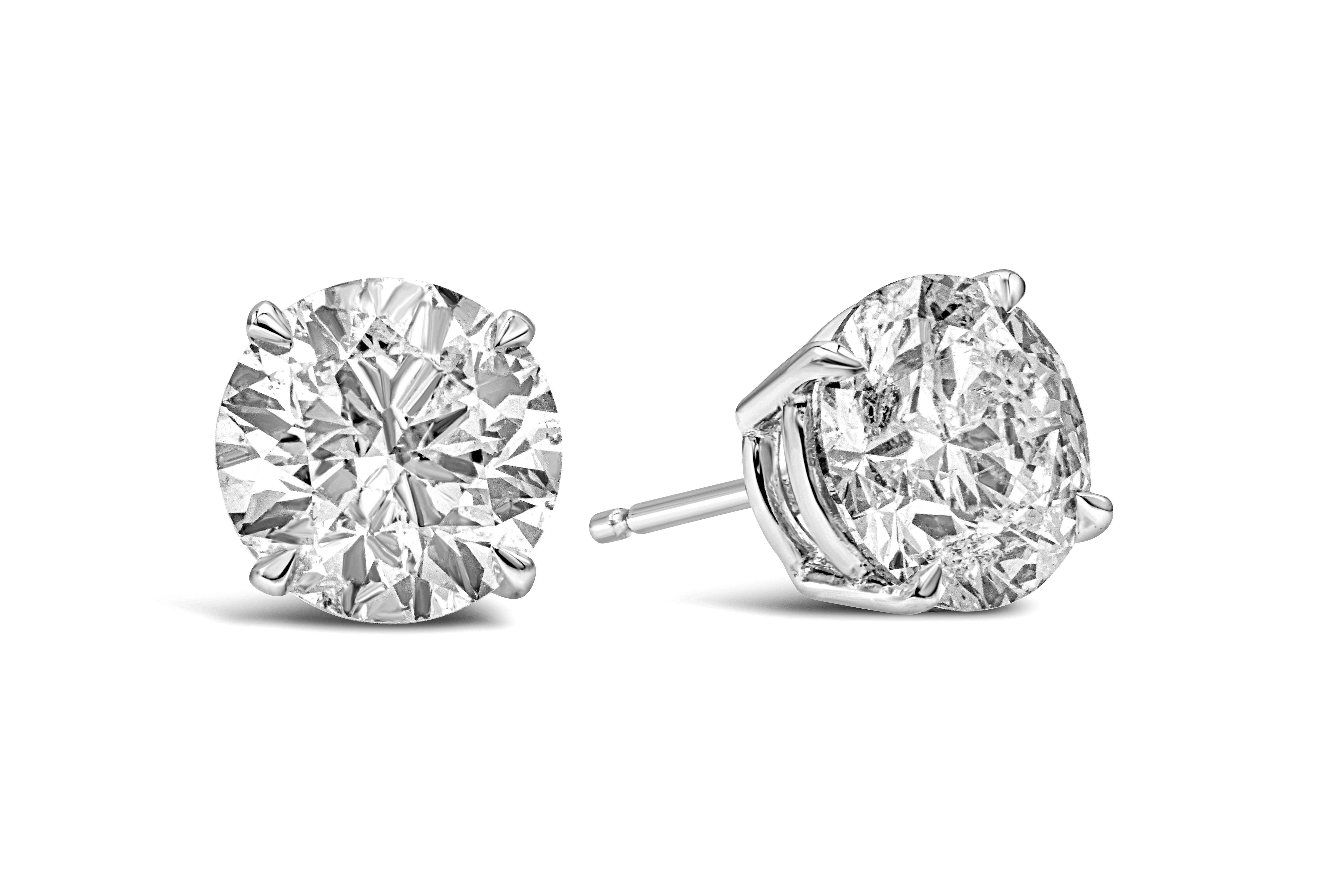 Classic pair of stud earrings showcasing a GIA certified two round brilliant cut diamonds, each weighing 2.01 carats, H-I color and I2 in clarity respectively. Set in a simple four prong basket setting. Finely made in 14k and 18k white gold.

Style