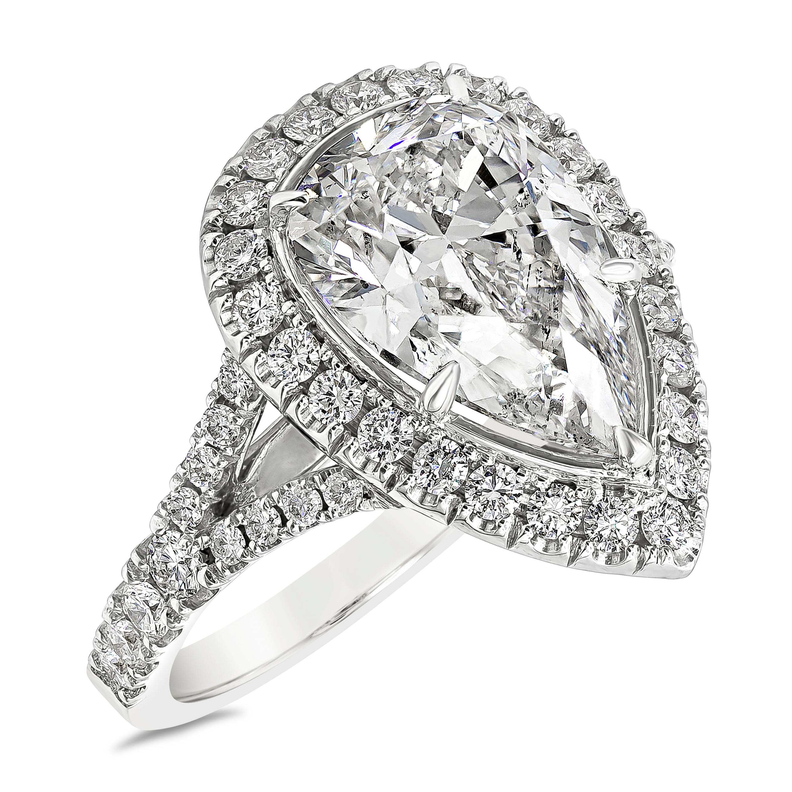 A contemporary engagement ring, showcasing a 4.03 carats pear shape diamond certified by GIA as H color and SI2 clarity, set on a five prong setting. Surrounded by a halo of round brilliant cut diamonds and accented by a diamond encrusted