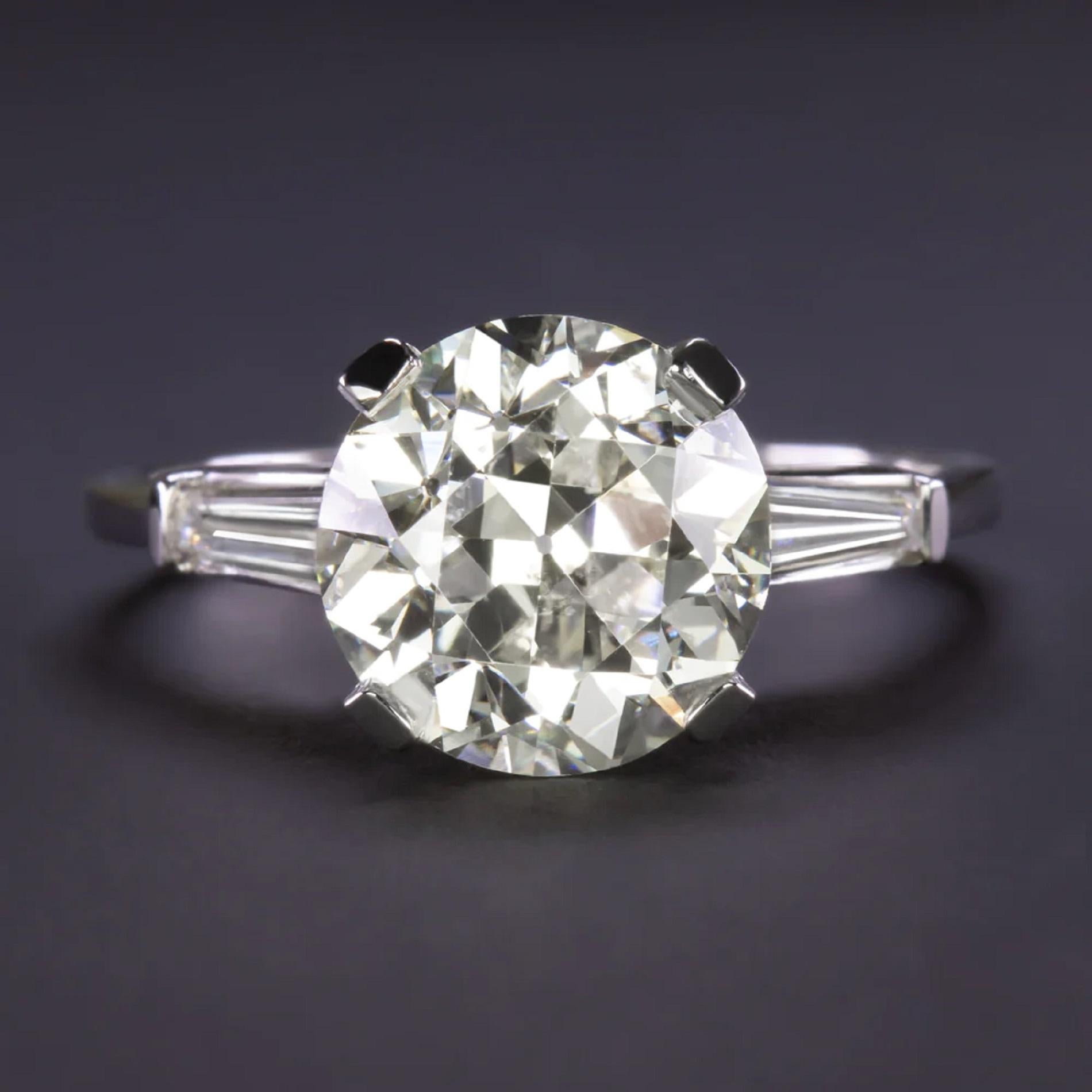vintage engagement ring has a classic elegance and an impressively large 4.13 carat old European cut diamond center! The shoulders of the stately setting glitter with tapered baguette diamonds for a timeless and sophisticated look.

Highlights:

-
