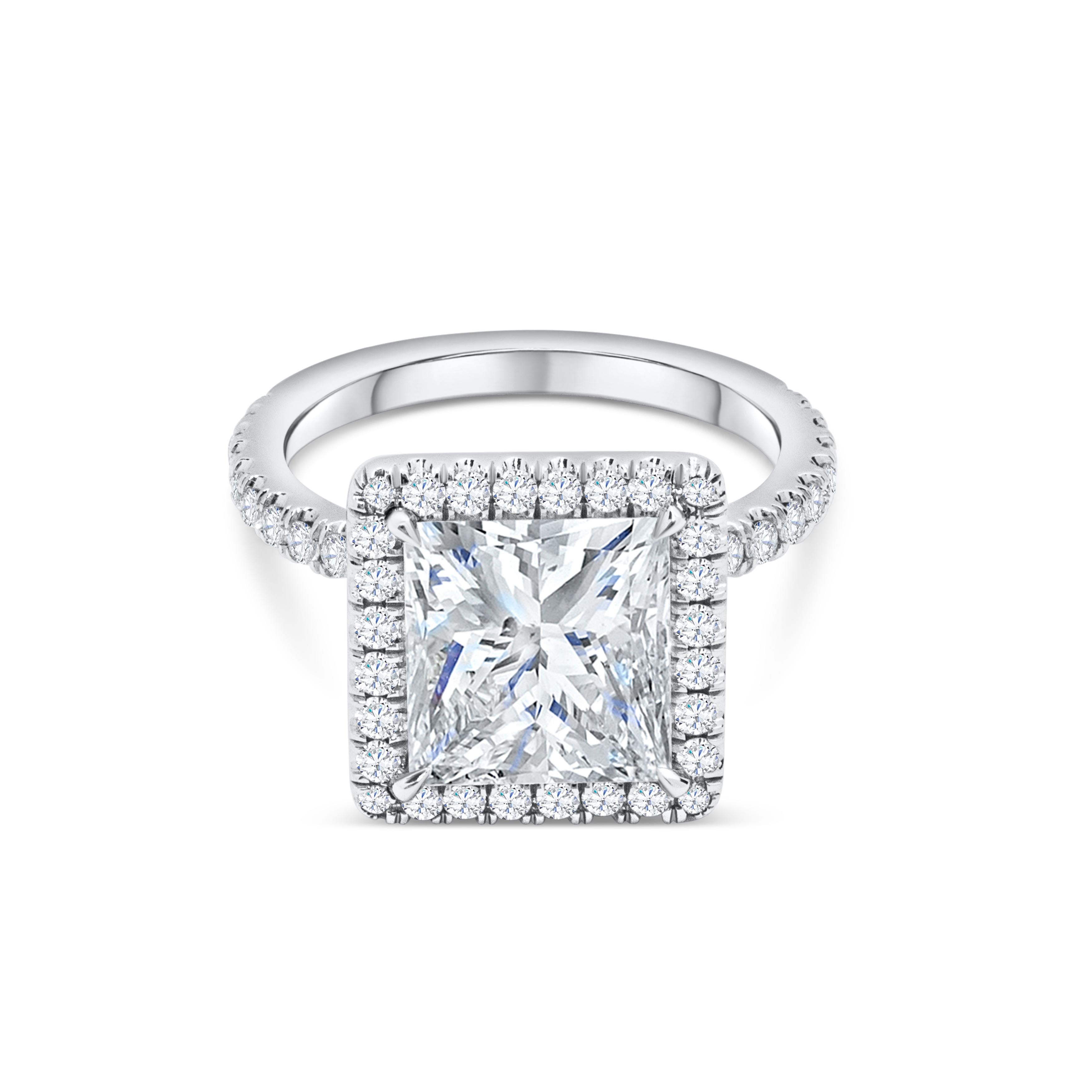 Showcasing a brilliant 4.07 carats princess cut diamond certified by GIA as I color, VS2 in clarity and set in a four prong basket setting. Surrounded by a single role of round brilliant diamonds in halo setting. Shank is diamond encrusted in half
