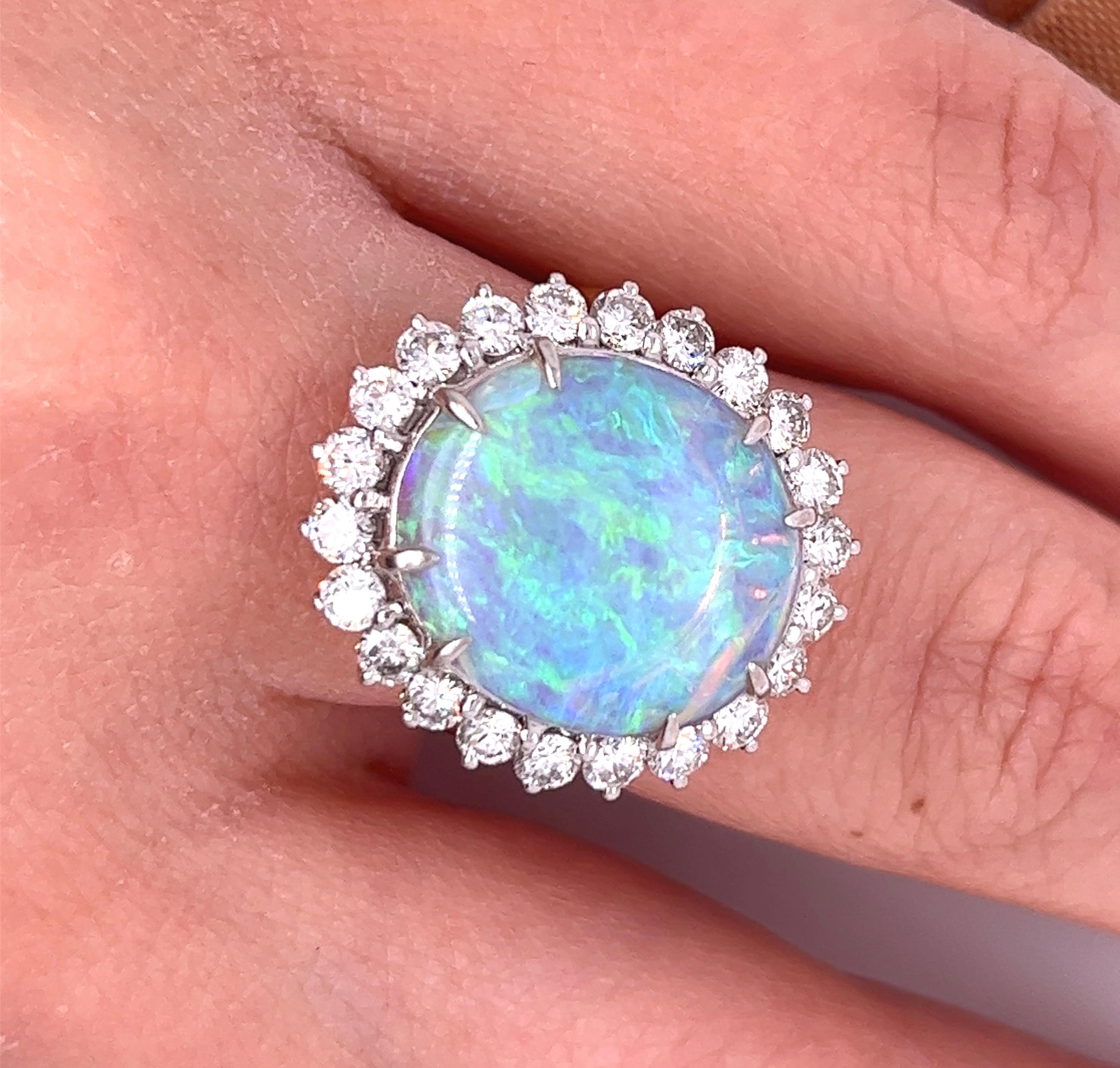 GIA certified 4.09-carat white opal with a vibrant array of colors. This Opal comes from the mines in Australia and is cabochon cut to perfection. 
The Opal is mounted in a thin, but sturdy, 18k yellow gold ring shank that integrates with a platinum