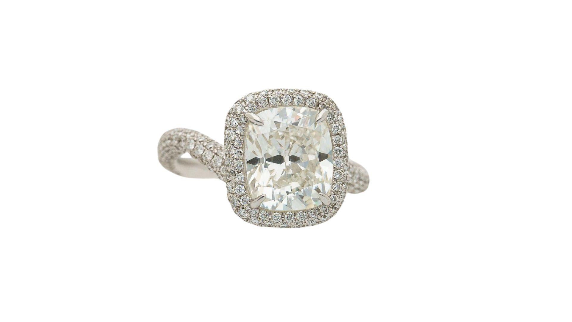 GIA Certified 4 Carat Cushion Cut H/VS1 Diamond Engagement Ring in 18K White Gold. 

GIA certified natural white diamond center stone with a cushion brilliant cut. Adorned with additional round-cut 1.43-carat white diamond side detailing along the
