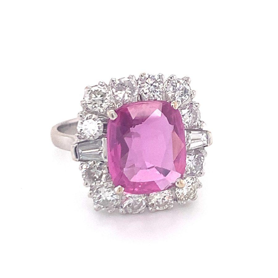 One mid-century pink sapphire and diamond 18K white gold ring centering one cushion cut, pink sapphire weighing 4.10 ct. with GIA Certificate No. 5161125066 stating no heat treatment. Enhanced by 14 round and tapered baguette cut diamonds weighing