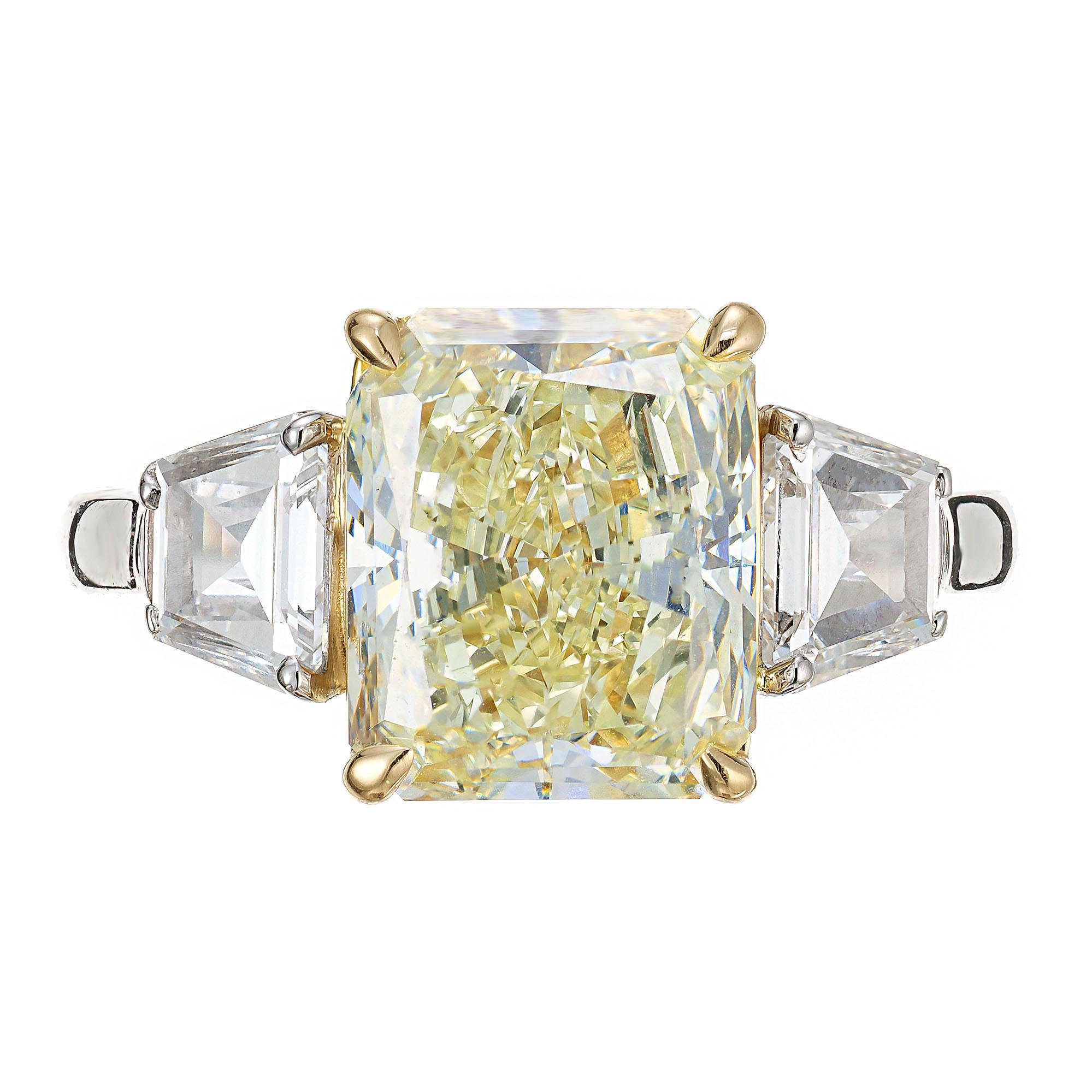 Yellow and white diamond engagement ring. GIA and EGL certified Light yellow natural cushion and radiant cut diamond center stone, set in platinum with 2 trapezoid cut side diamonds. 18k yellow gold four prong crown. Graded by the EGL as light