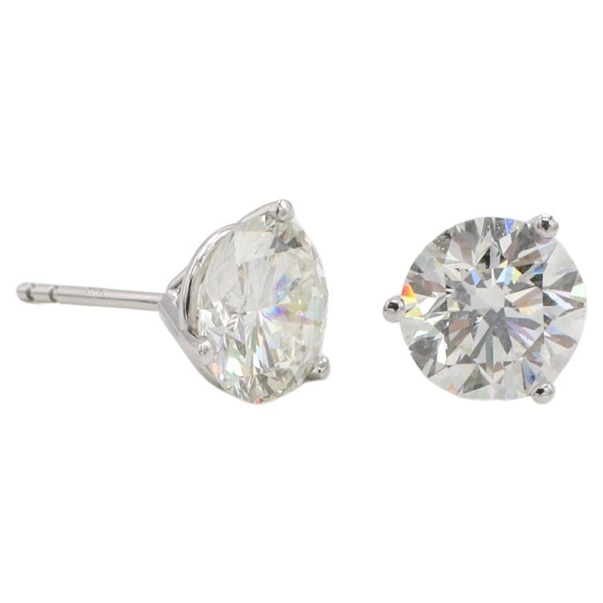 GIA Certified 4.12 Carat Total Weight Natural Diamond Martini Set Stud Earrings 
Metal: 14k white gold
GIA report numbers: 6237209803, 2239416159
Diamonds: 2.11 J SI1 & 2.01 I SI2 round natural diamonds
Metal: 14k white gold
Backs: Friction backs 
