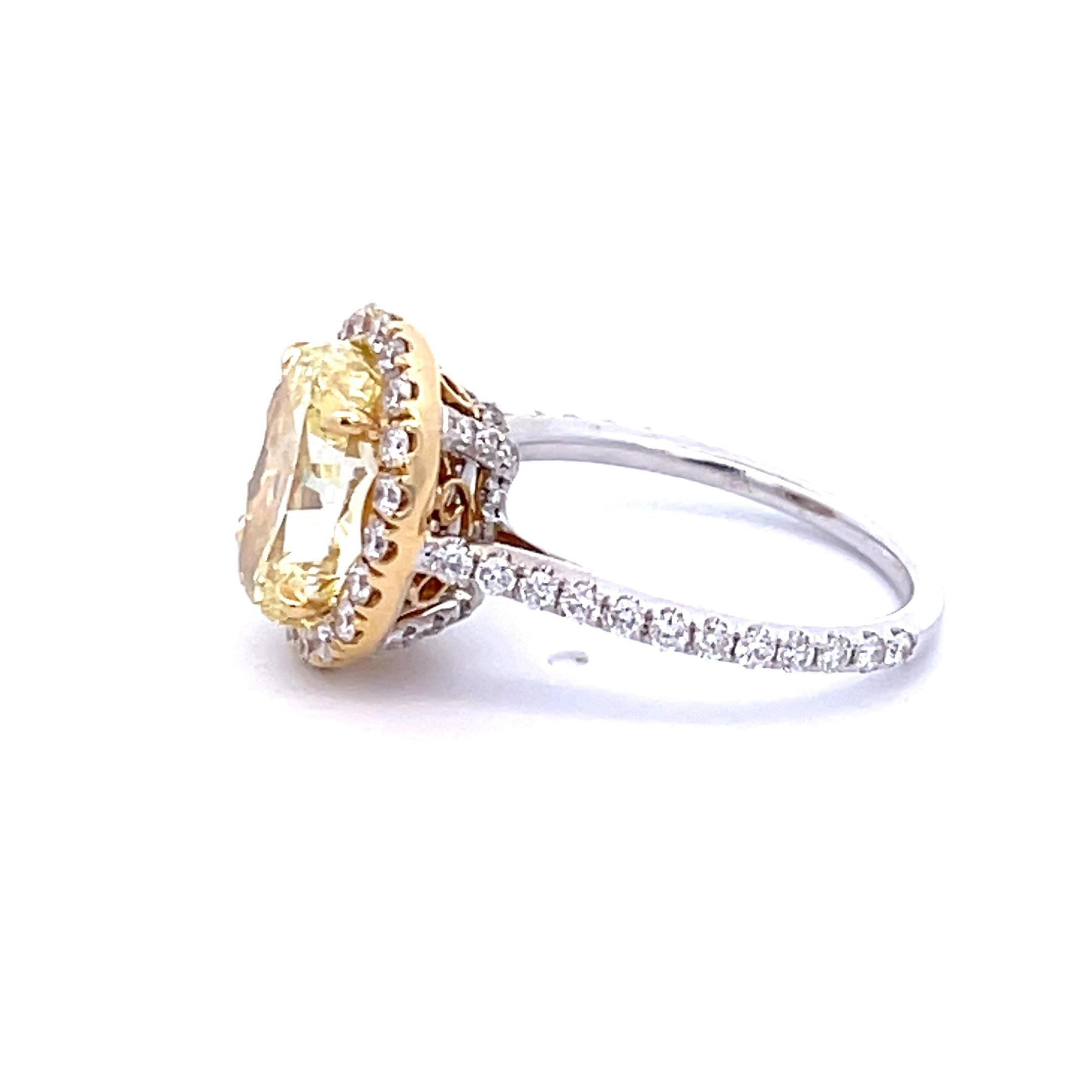 Fall in love with this GIA Certified 4.13 Carat Fancy Yellow Oval Diamond Engagement Ring. The 
