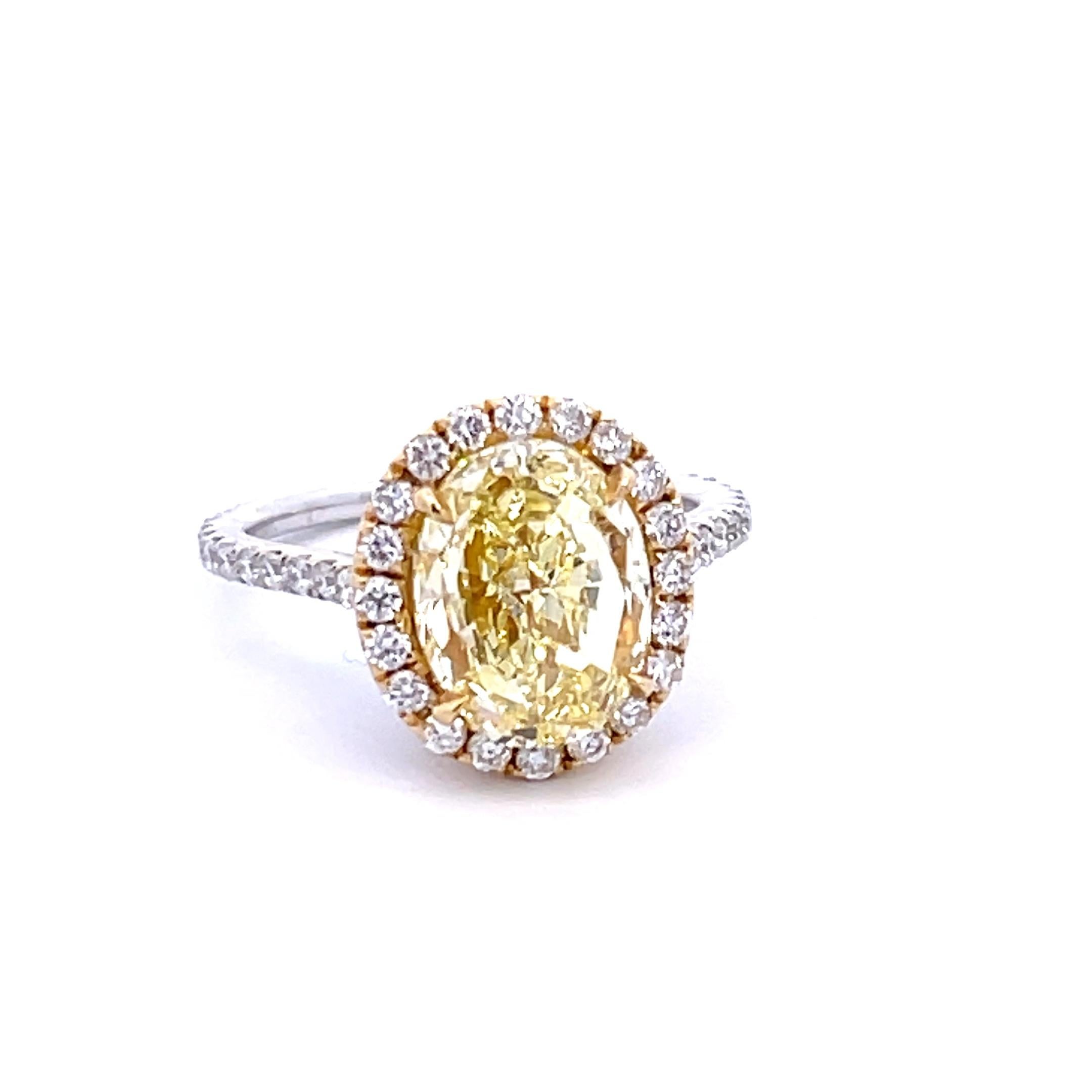 GIA Certified 4.13 Carat Fancy Yellow VS1 Oval Diamond Halo Engagement Ring In New Condition For Sale In Aventura, FL