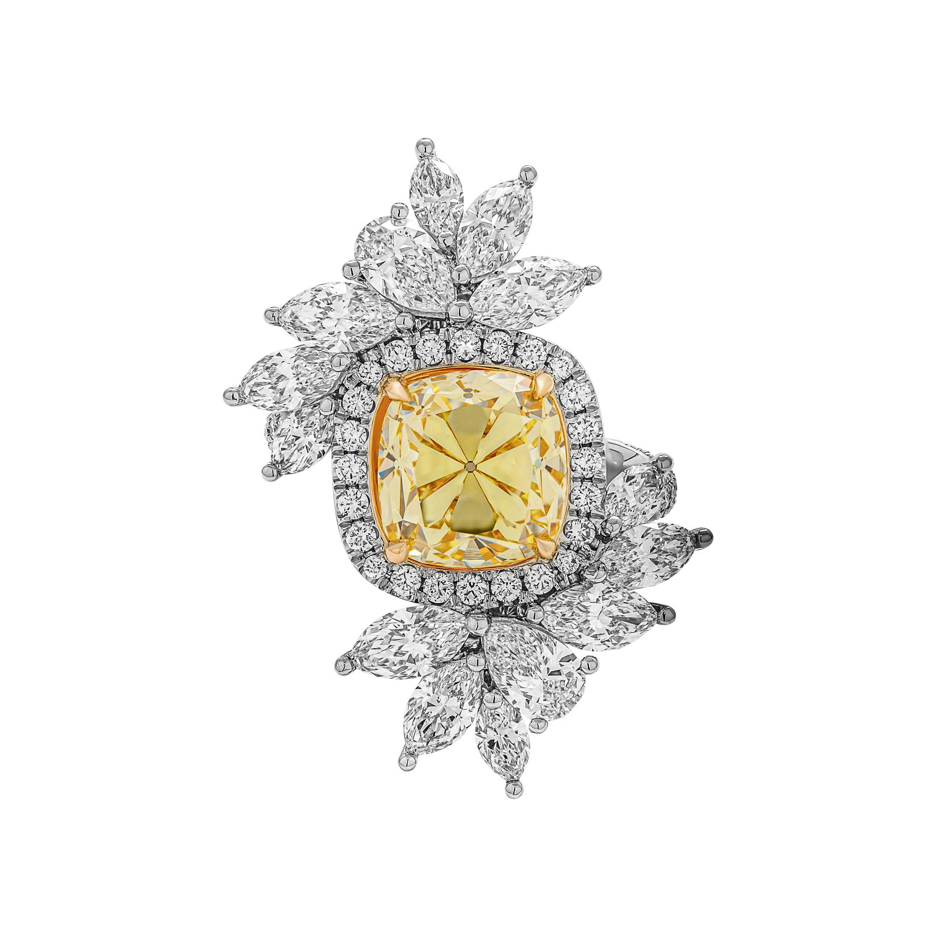 Custom made platinum and 18kt yellow gold ring featuring one GIA certified 4.13ct Fancy Intense Yellow Vs1 Cushion Brilliant Cut diamond, 12 x Marquise Cut white diamonds, 2.24ct and 2 x Pear shaped white diamonds, 0.56ct.