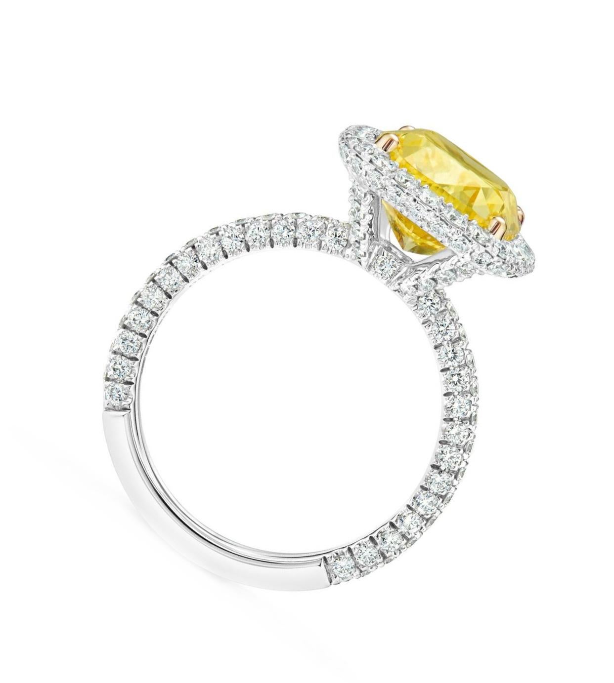 This exquisite custom-ordered ring, yet to be crafted, represents a unique and personal expression of elegance and exclusivity. At its heart lies a breathtaking 4.14 carat Fancy Yellow cushion-shaped diamond, certified by GIA for its exceptional