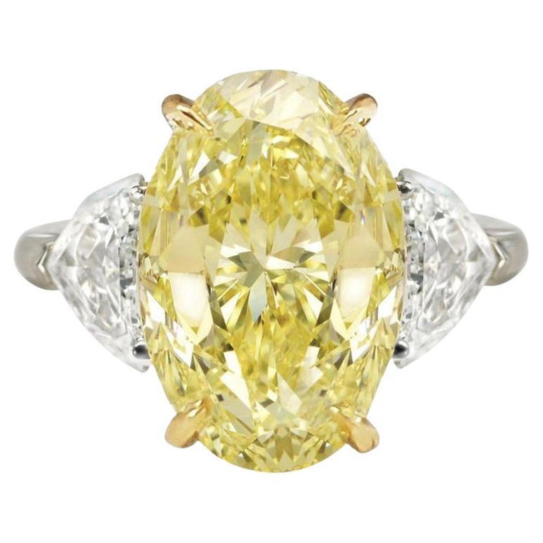 4.36-carat fancy yellow oval and white half moon diamond ring, 2021