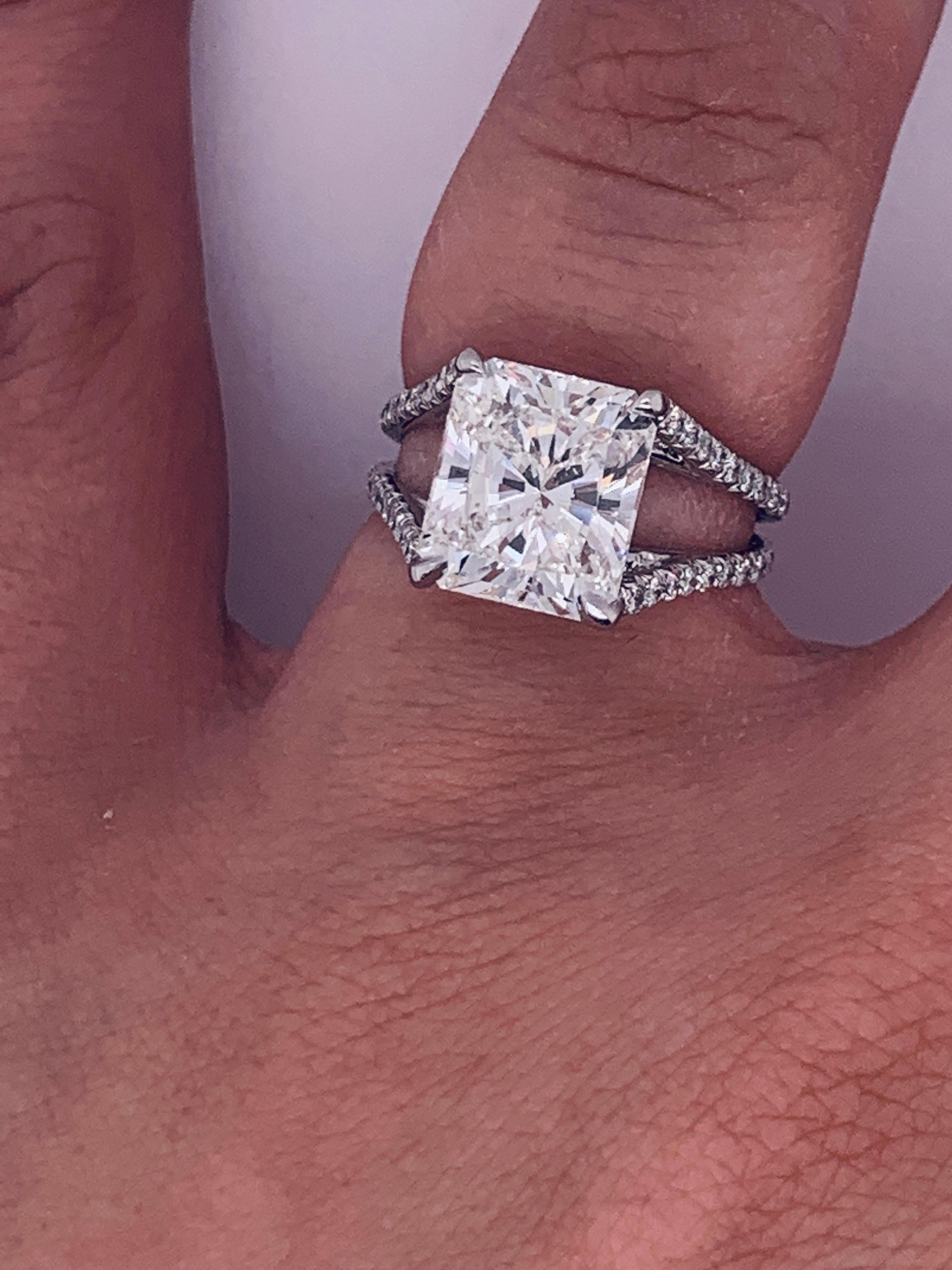 Magnificent GIA certified diamond engagement ring with Ideal proportion Radiant cut diamond in the center, weighing 4.18 carats J color Internally Flawless  in clarity, surrounded by 1.00 carat of round brilliant cut diamonds. Platinum.
Comes with