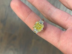 GIA Certified 4.20 Carat Fancy Intense Yellow Radiant Cut Three-Stone Ring