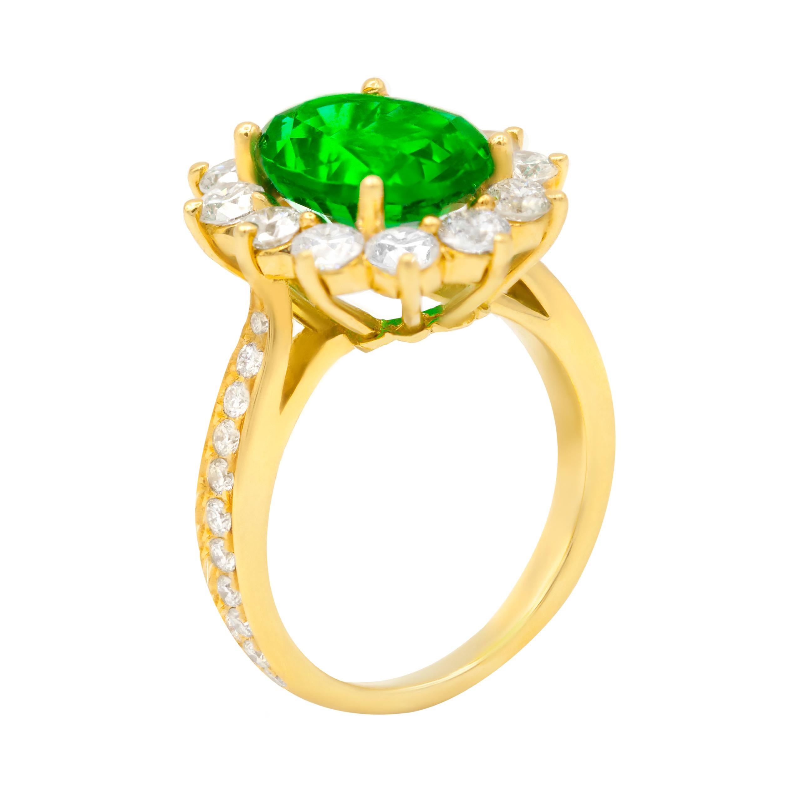 18K Yellow Gold vibrant green emerald ring. 
The cneter stone is 4.20 Carat Oval Shaped Green emerald, surrounded by 1.80 Carats of round brilliant cut diamonds. set in yellow gold.
