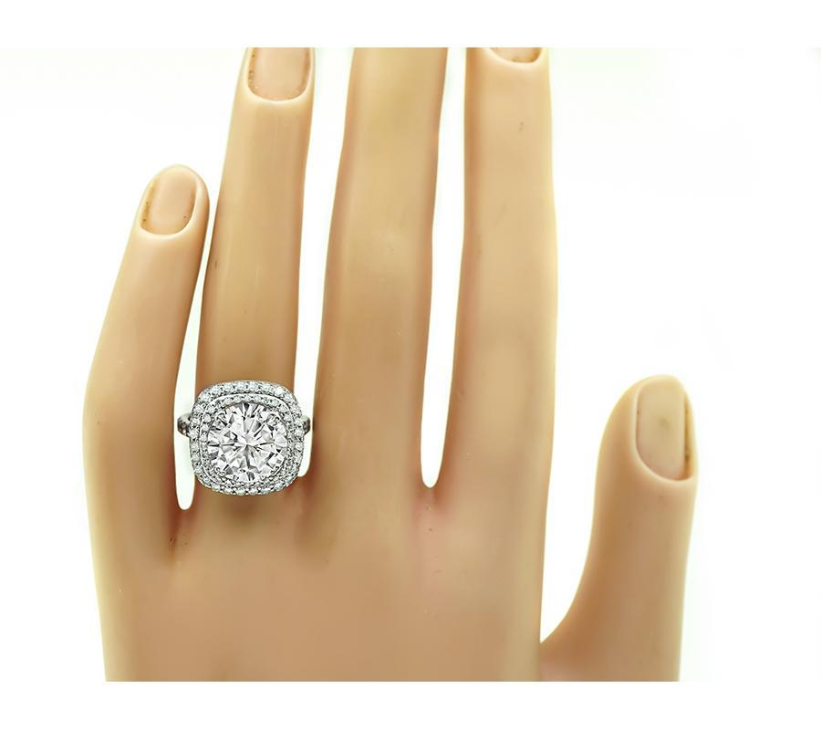 This is an elegant 14k white gold engagement ring. The ring is centered with sparkling GIA certified round brilliant cut diamond that weighs 4.20ct. The color of the diamond is J with I1 clarity. The center diamond is accentuated by dazzling round