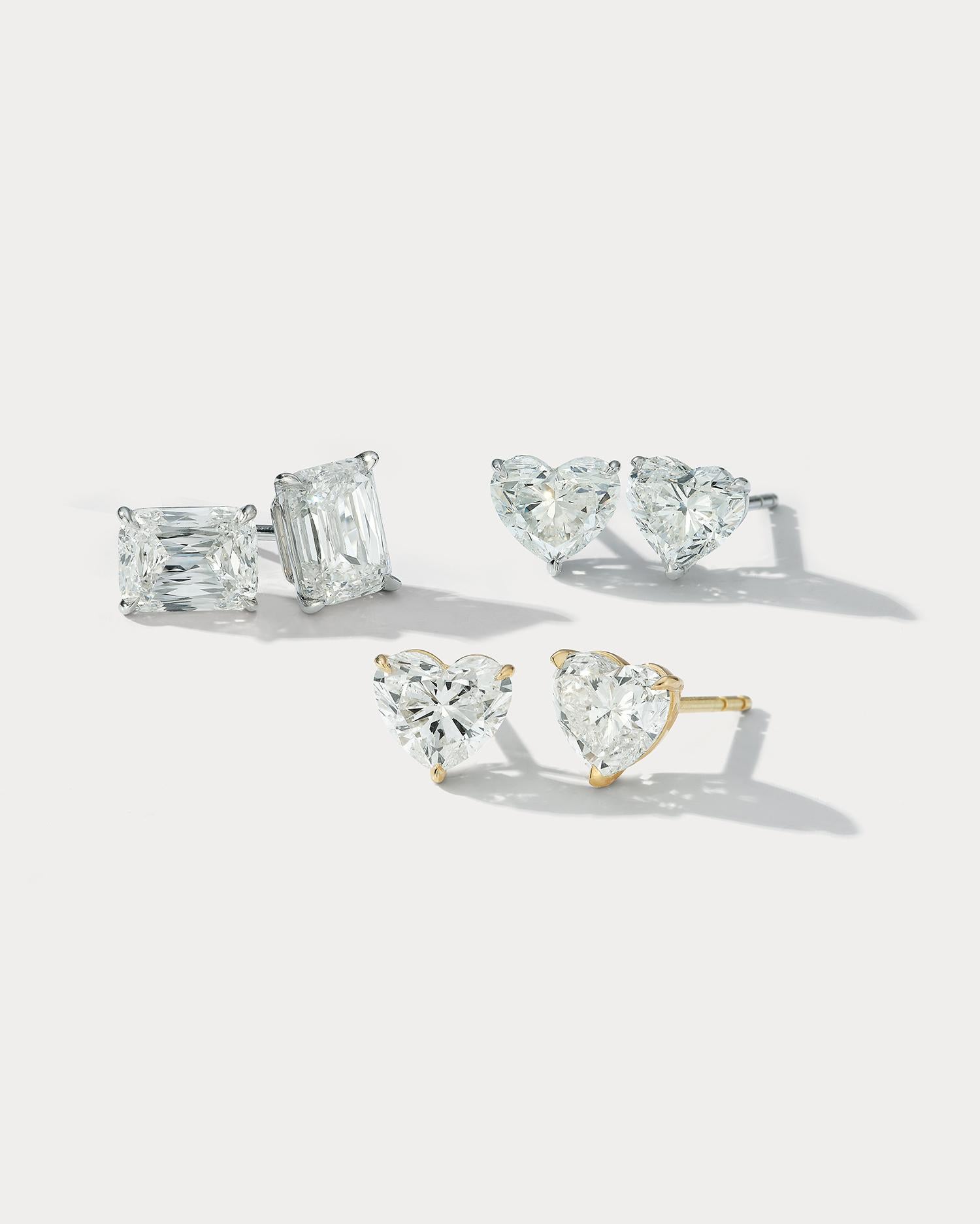 Fall in love with these stunning 4.21 carat total weight heart shaped diamond stud earrings, set in 18k yellow gold. The warm glow of the yellow gold perfectly complements the fire and brilliance of the heart shaped diamonds, creating a mesmerizing