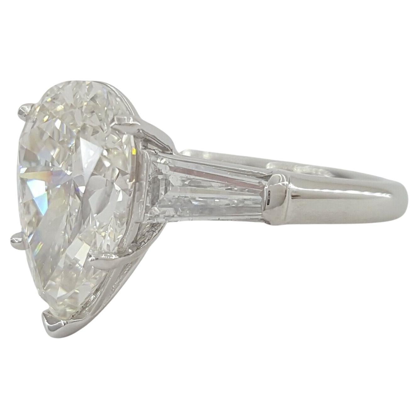 An exquisite GIA certified 4.24 carat pear cut diamond with excellent brightness and 100% eye clean 
The ring weighs 7.5 grams, size 5.75, the center stone is a Natural Pear Brilliant Cut diamond weighing 4.24 ct, I in color, VVS2 in clarity, 63.6%