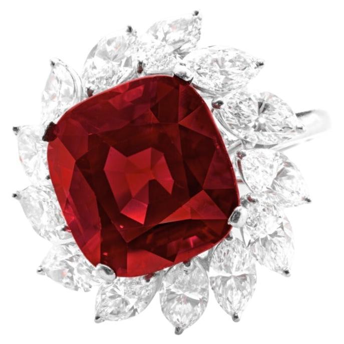 Centering a cushion-shaped ruby, flanked by two trapezoids shaped diamonds and a pave of round brilliant cut diamonds

untreated ruby weighing 4.26 carats
Size 6
Platinum
Accompanied by GIA report
