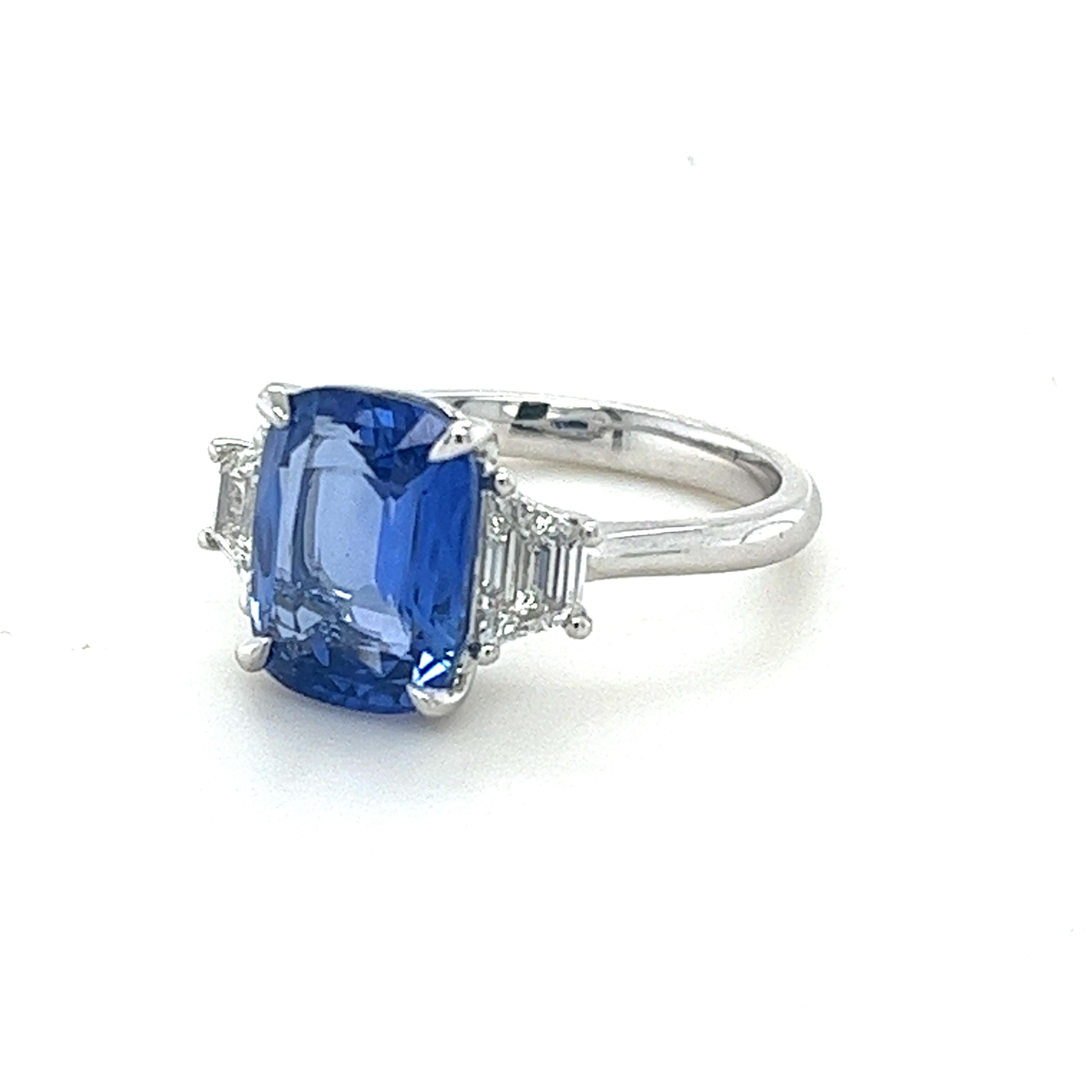 GIA Certified cushion Ceylon Sapphire weighing 4.28 carats
Measuring (10.78x8.16x4.76) mm
Diamond quality is G-Si1
Trapezoid Diamonds weighing .68 carats
Set in platinum ring
6.13 grams