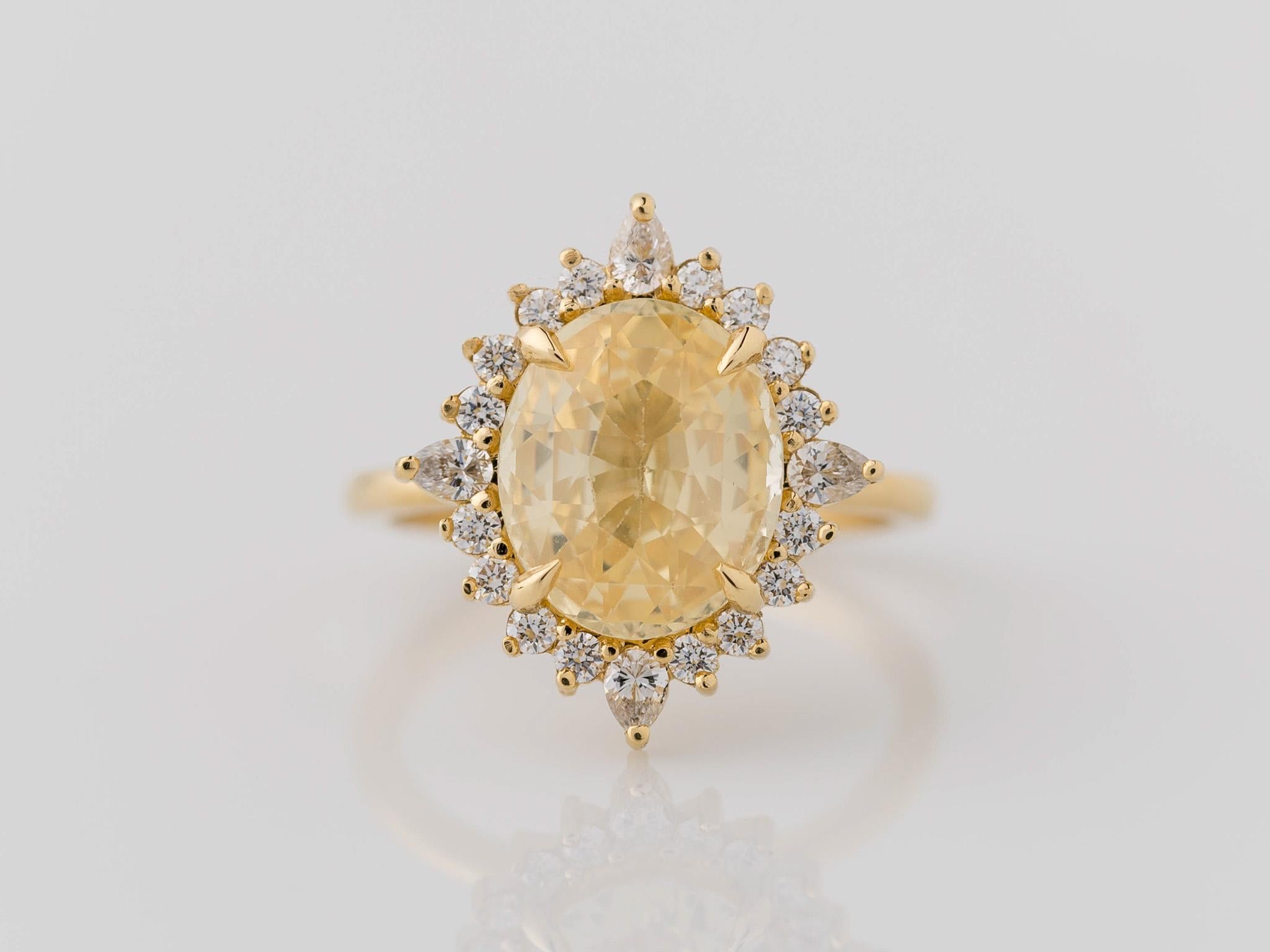 Celebrate love's brilliance with this enchanting GIA certified oval unheated/natural yellow sapphire cluster diamond engagement ring. Crafted in lustrous 18k yellow gold, the vibrant yellow sapphire commands attention, surrounded by a mesmerizing