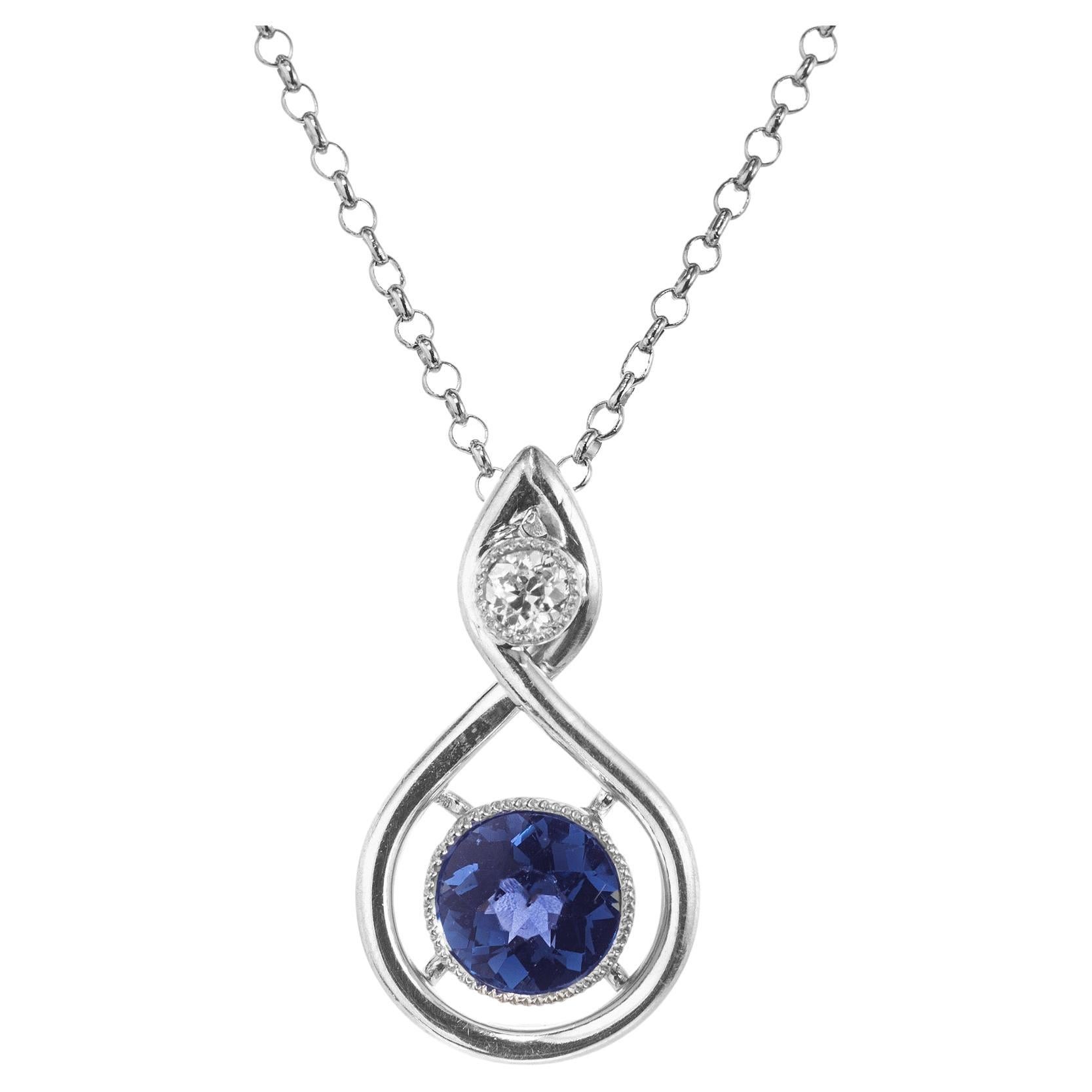 This 1920's Art Deco pendant is set with amazing .43 carat round blue sapphire from Yogo Gulch, Montana. GIA certified in a custom platinum pendant mounting with a .40 round diamond on top. The GIA has certified the sapphire as natural, no heat.