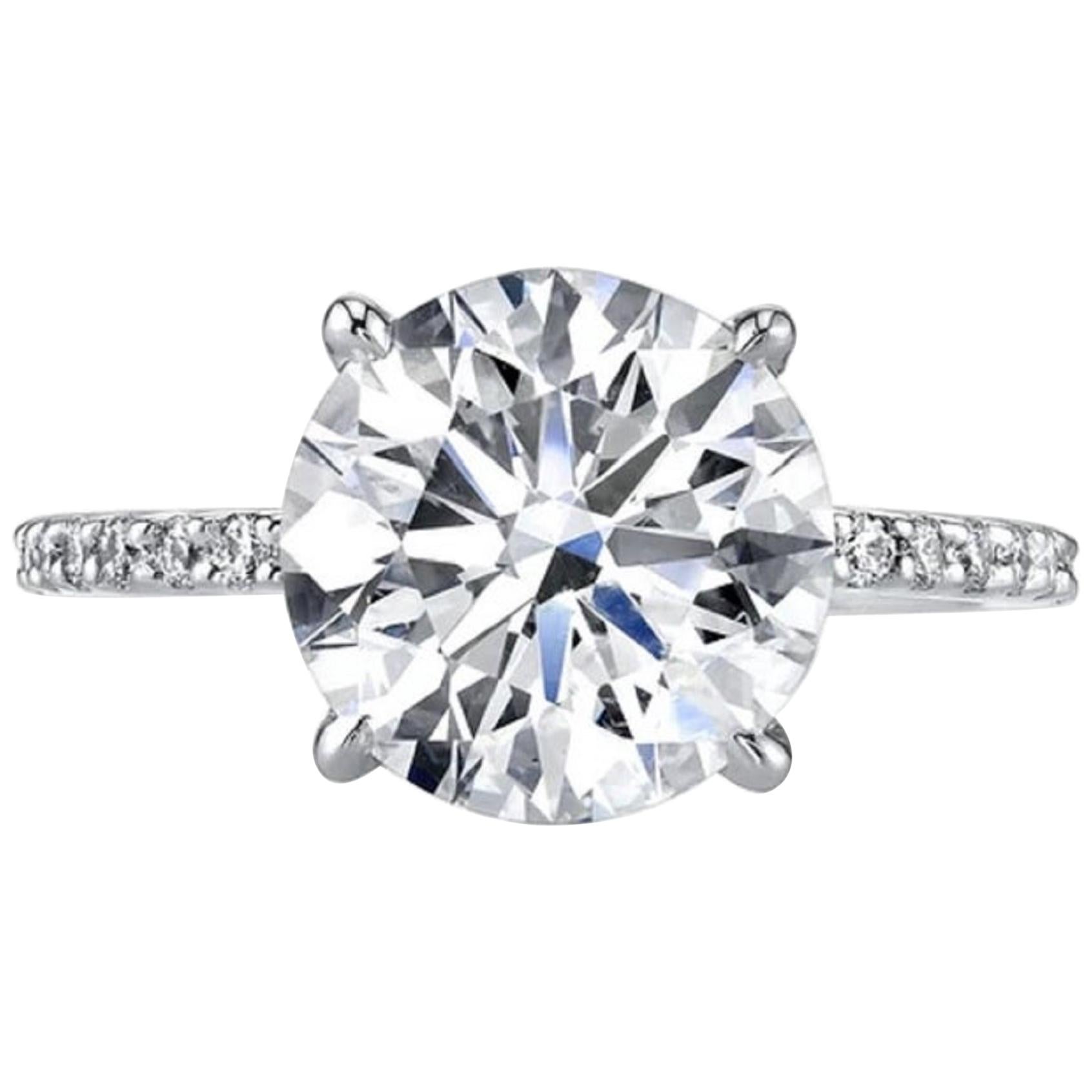 An amazing diamond ring with a beautiful 3.25 carat round brilliant cut diamond plus a delicate pave of round brilliant cut diamonds all vs1  in clarity and d color 