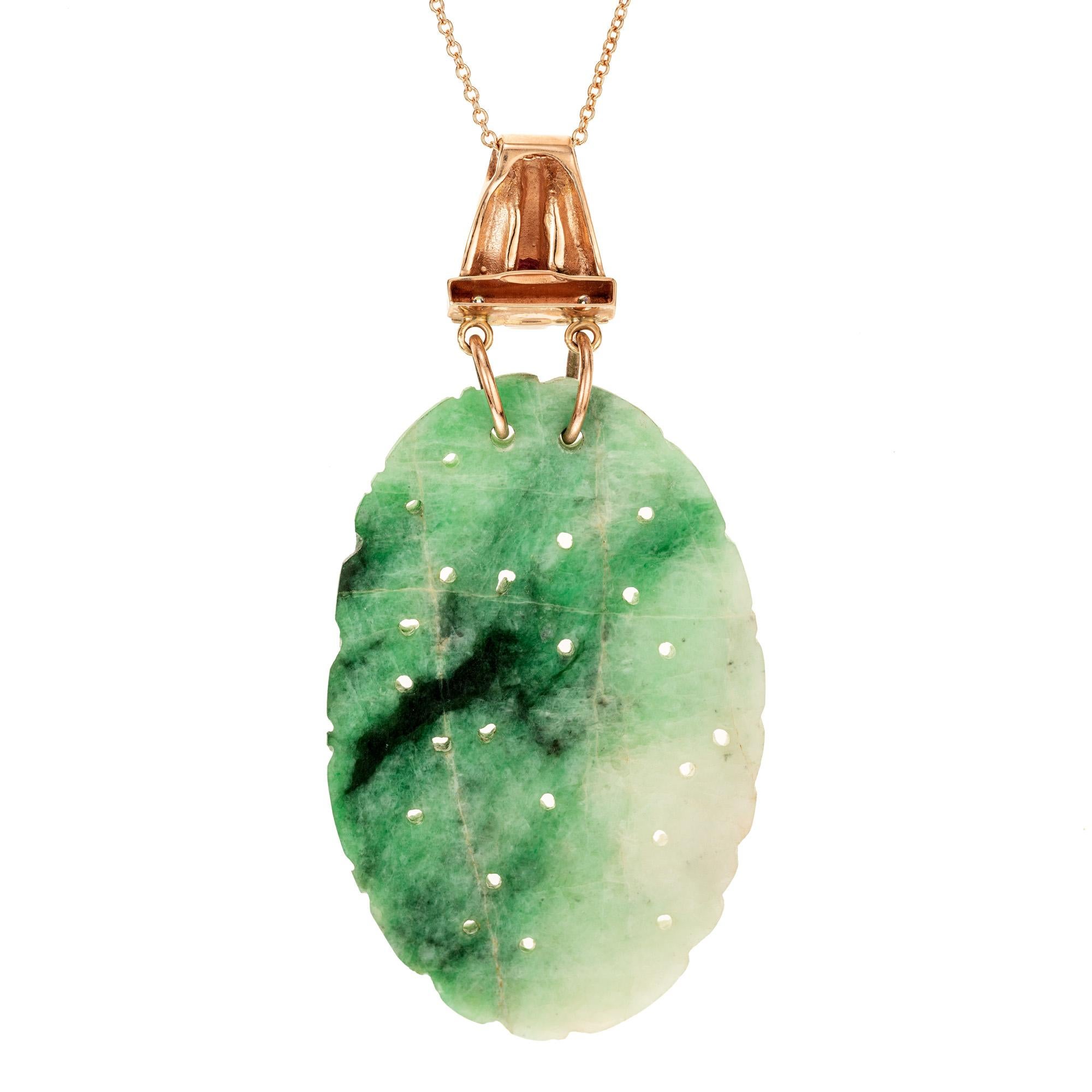 Retro Art Deco 1940's jade, diamond and ruby pendant necklace. GIA certified 43.79cts oval variegated jadeite jade, polished and carved with a 14k rose gold bail, accented with 2 single cut diamonds and 2 square cut red rubies. Certified all