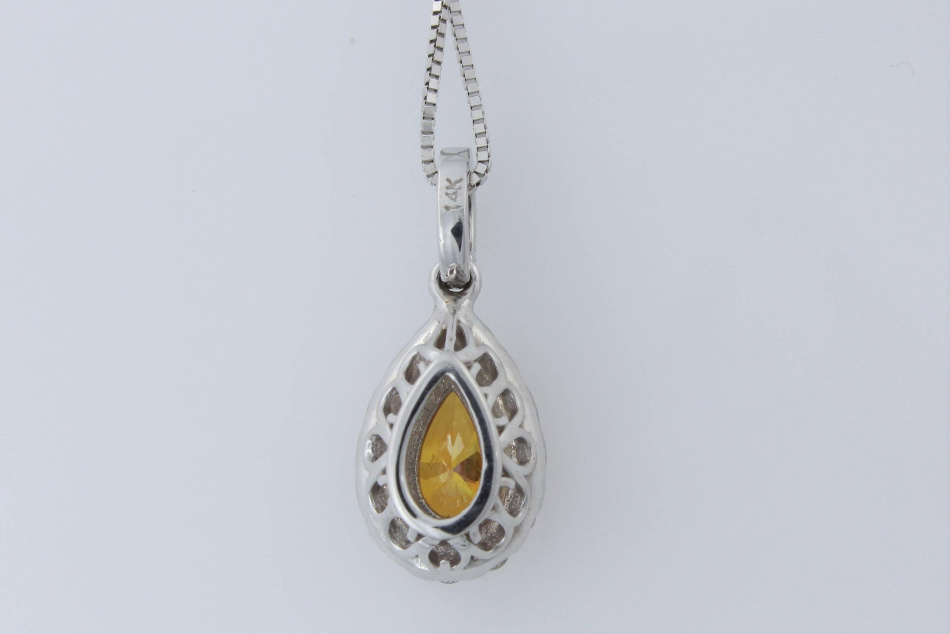 Colored Diamond!  Presenting a rare GIA Certified Natural Fancy Deep Yellowish Orange .44 carat  pear shape diamond set in a classic, micro-prong, 14 karat white gold, diamond halo pendant!  The pendant contains 19 white (G-H color) and clean (VS