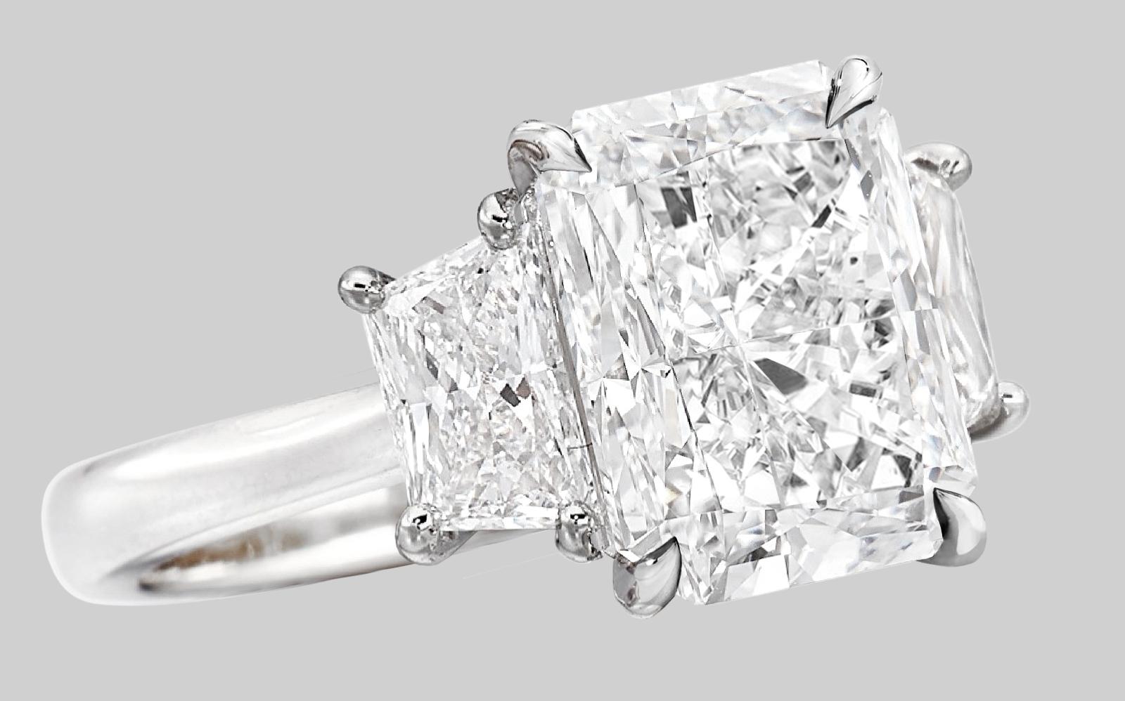 This stunning ring features a GIA-certified radiant cut diamond weighing 4.40 carats, set in a sleek platinum band. The center stone is an H color grade, ensuring a bright and near-colorless appearance, while its VVS2 clarity grade speaks to its