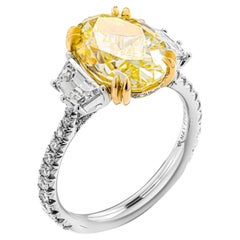 GIA Certified 4.46 Carat Fancy Yellow Oval Cut Three-Stone Ring