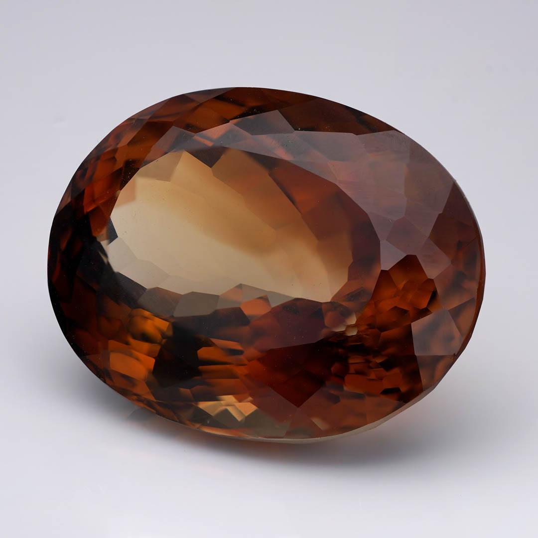 This extraordinary 44.88-carat brown Topaz is a statement in warmth and brilliance. Expertly faceted into a large oval cut, the gem radiates rich tones of cognac, amber, and deep mocha – creating a captivating interplay of earthy hues and fiery