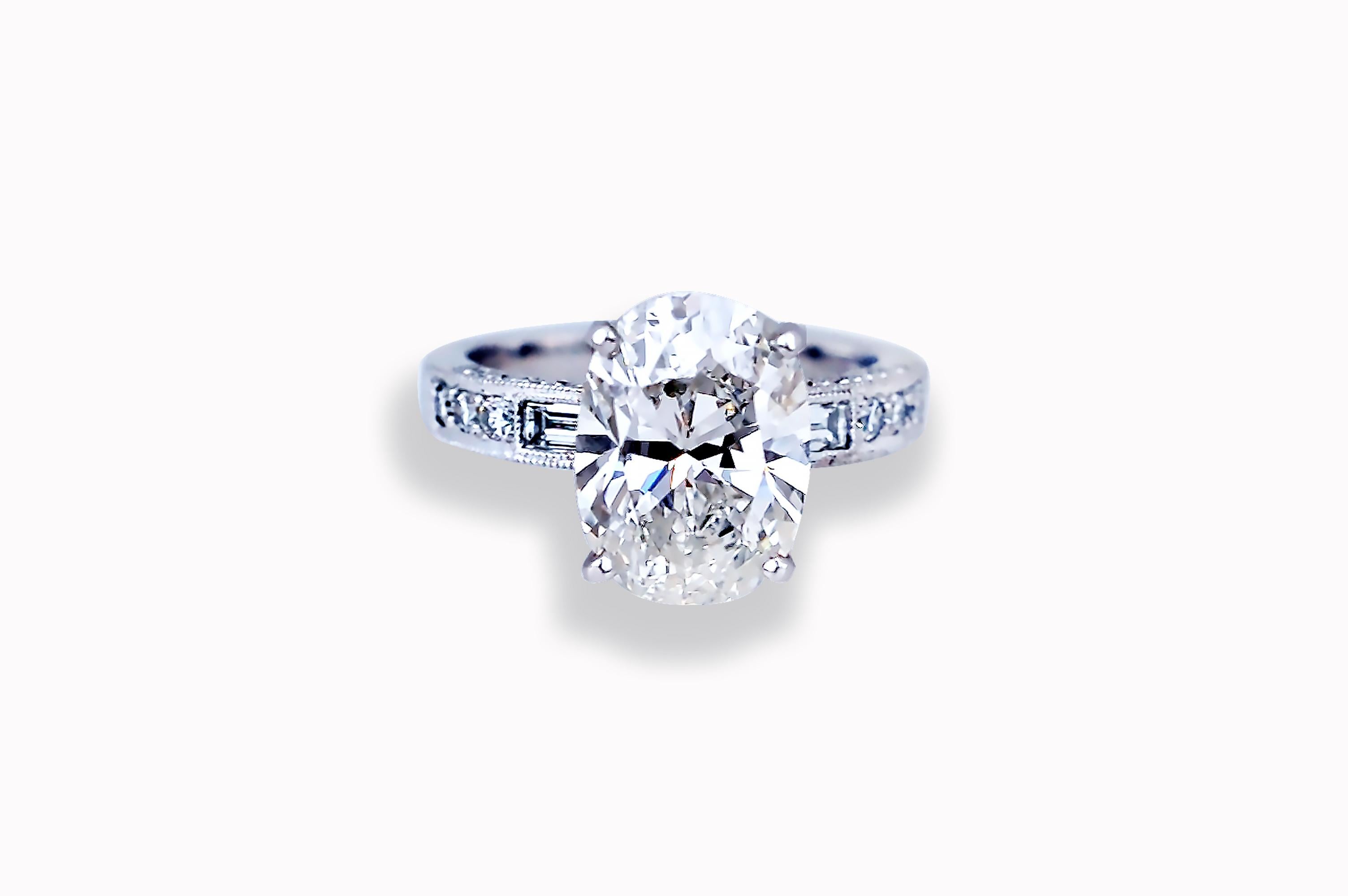 This oval diamond engagement ring has all the looks of the most popular engagement ring design currently.  The center diamond is GIA certified with 10378029.  The center stone is H color and VS2 clarity.  The measurements are 12.43 x 9.09 x 5.92 mm.