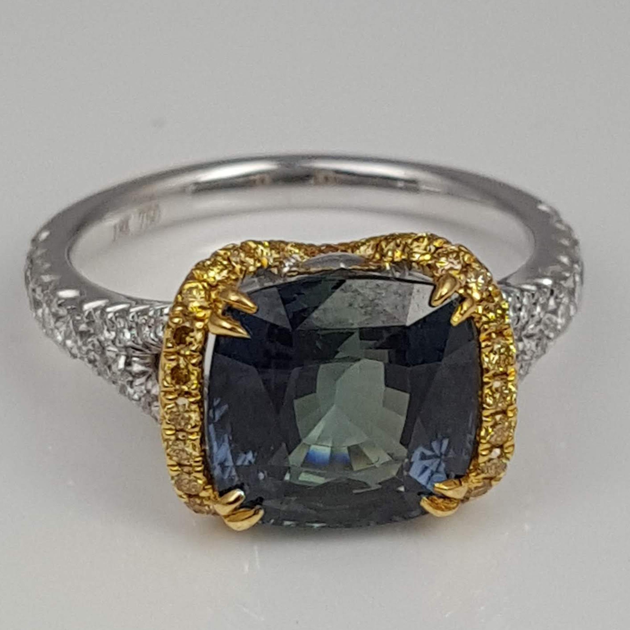 With a GIA Certified 4.50 carat cushion cut Green Sapphire center, among 0.24 carats round yellow diamonds and 0.36 carats white diamonds (total diamond weight 0.60 carats), this ring shines from every angle.

GIA Certification details (see