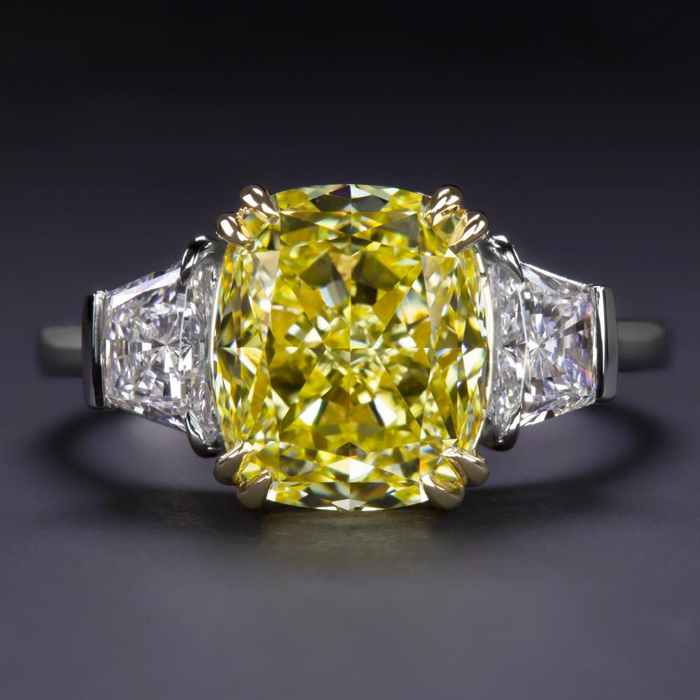 This Beautiful Classic engagement ring from Antinori Fine Jewels features an over 3.53 carat fancy vivid yellow radiant cut diamond with GIA certificate flanked by trapezoid pure diamonds.

The mounting is platinum and 18 karats Yellow Gold. Truly