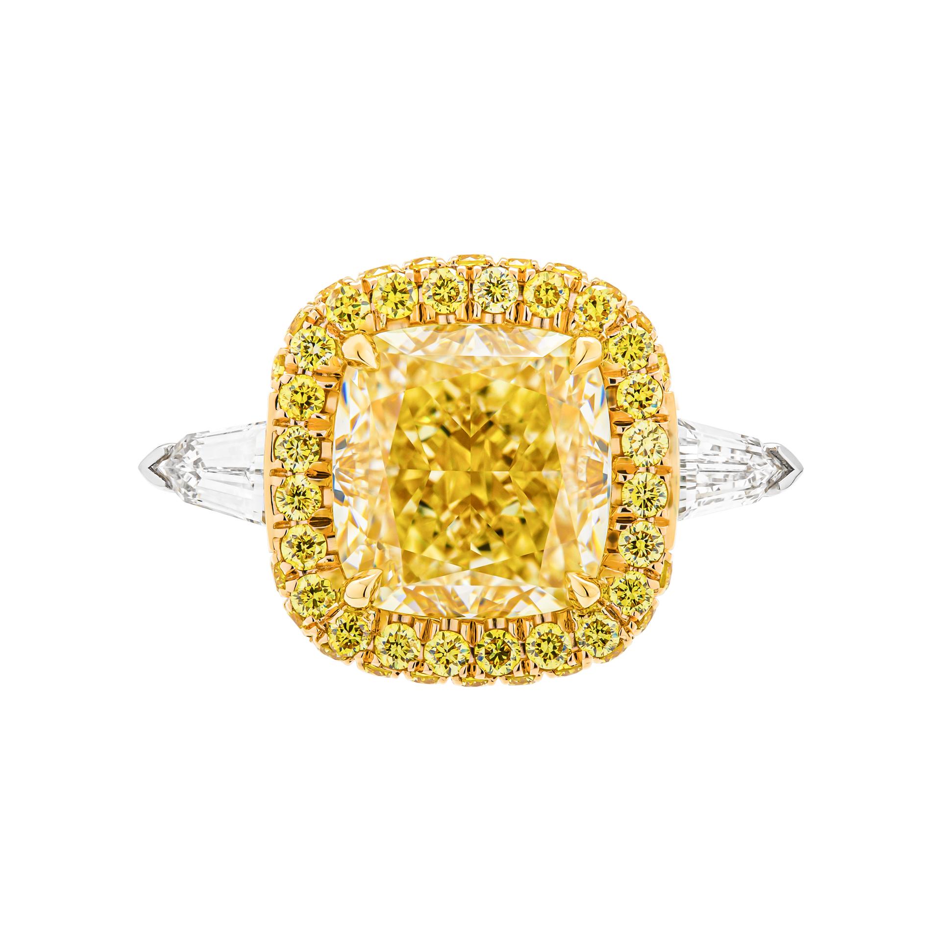 3 stone ring in Platinum & 18K Yellow Gold
Cathedral diamond shank, diamond wrap; diamond bridge design
Center stone: 
4.50ct Natural Fancy Light Yellow Even VVS1 Cushion Shape Diamond GIA#2225059650 
Side stones: 0.42ct F color VS clarity Bullet