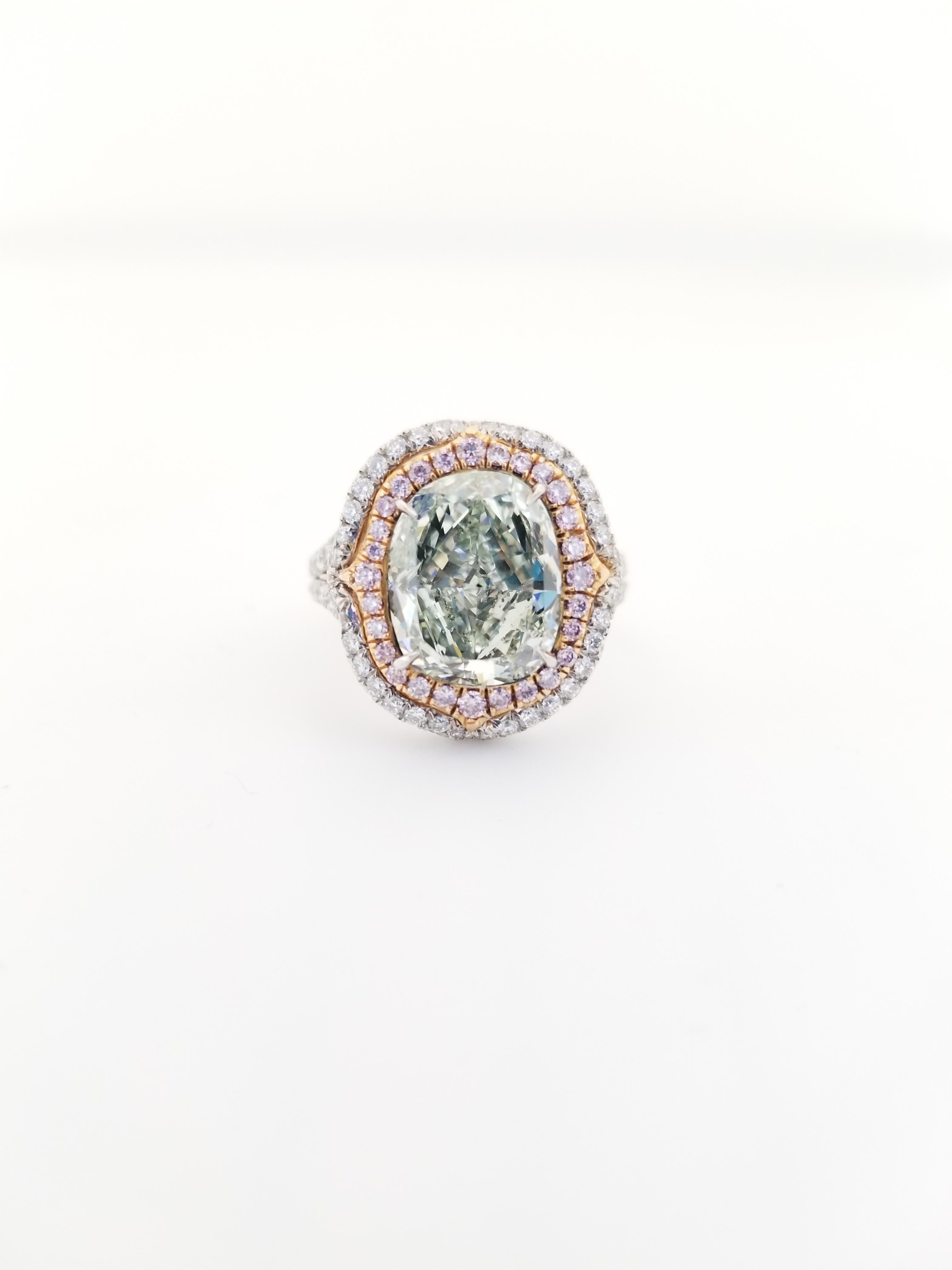 Beautiful natural fancy yellowish green cushion cut diamond weighing 4.51 carats. Certified by GIA. surrounded by round pink and white diamonds. set in 4 prong double halo setting. Its transparency and luster are excellent. 18K/Platinum white gold,