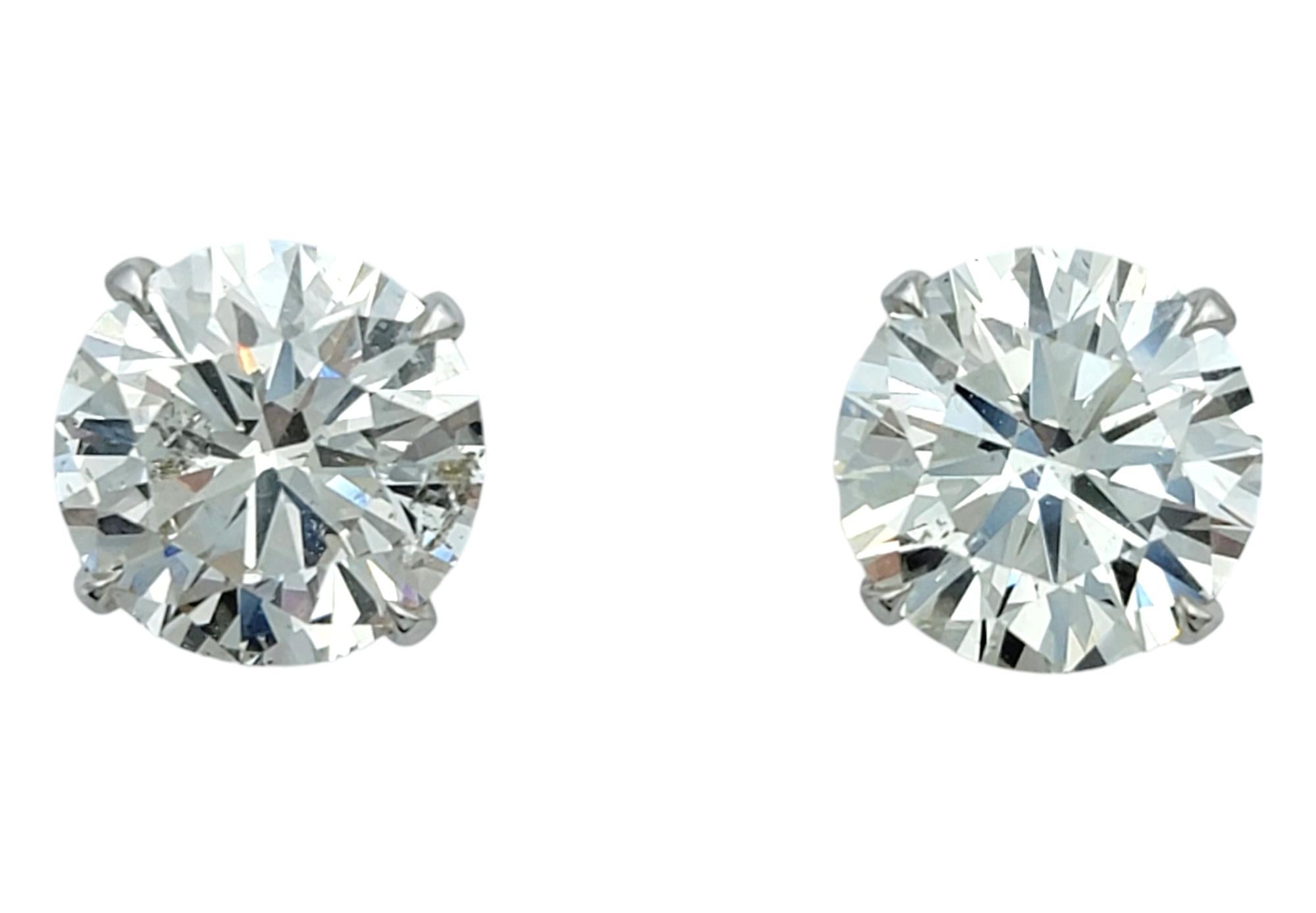 Elevate your elegance with these breathtaking round brilliant cut diamond studs, a timeless symbol of sophistication and grace. With a total carat weight of 4.51, these diamonds exude remarkable brilliance, each facet capturing light in a dazzling