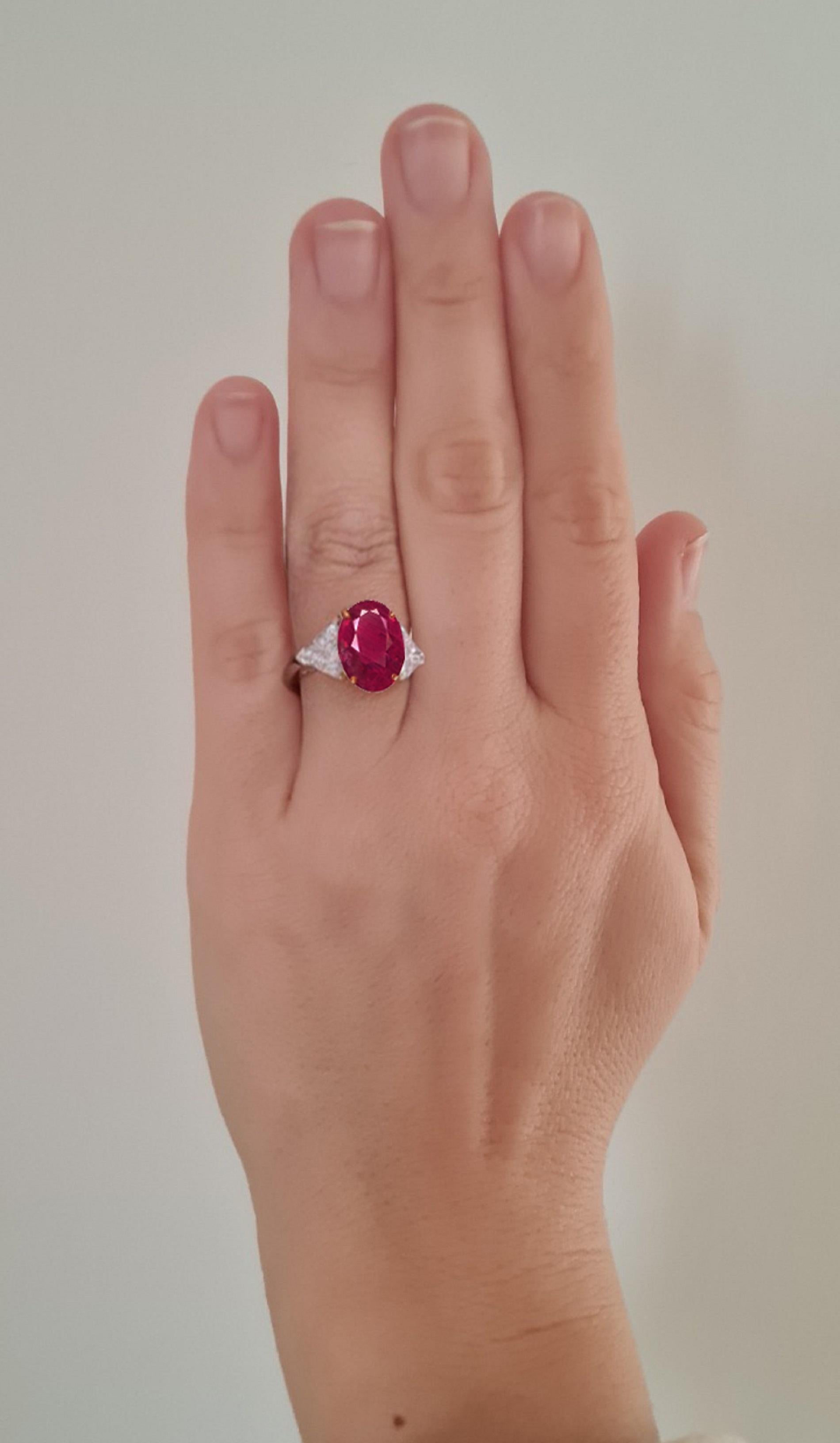 Elevate your style with this exquisite ring, a true testament to timeless beauty and exceptional craftsmanship. At its heart lies a resplendent 4.50-carat oval Burma ruby, a gem of rare allure and intense vibrancy. The rich red hue of the ruby is a