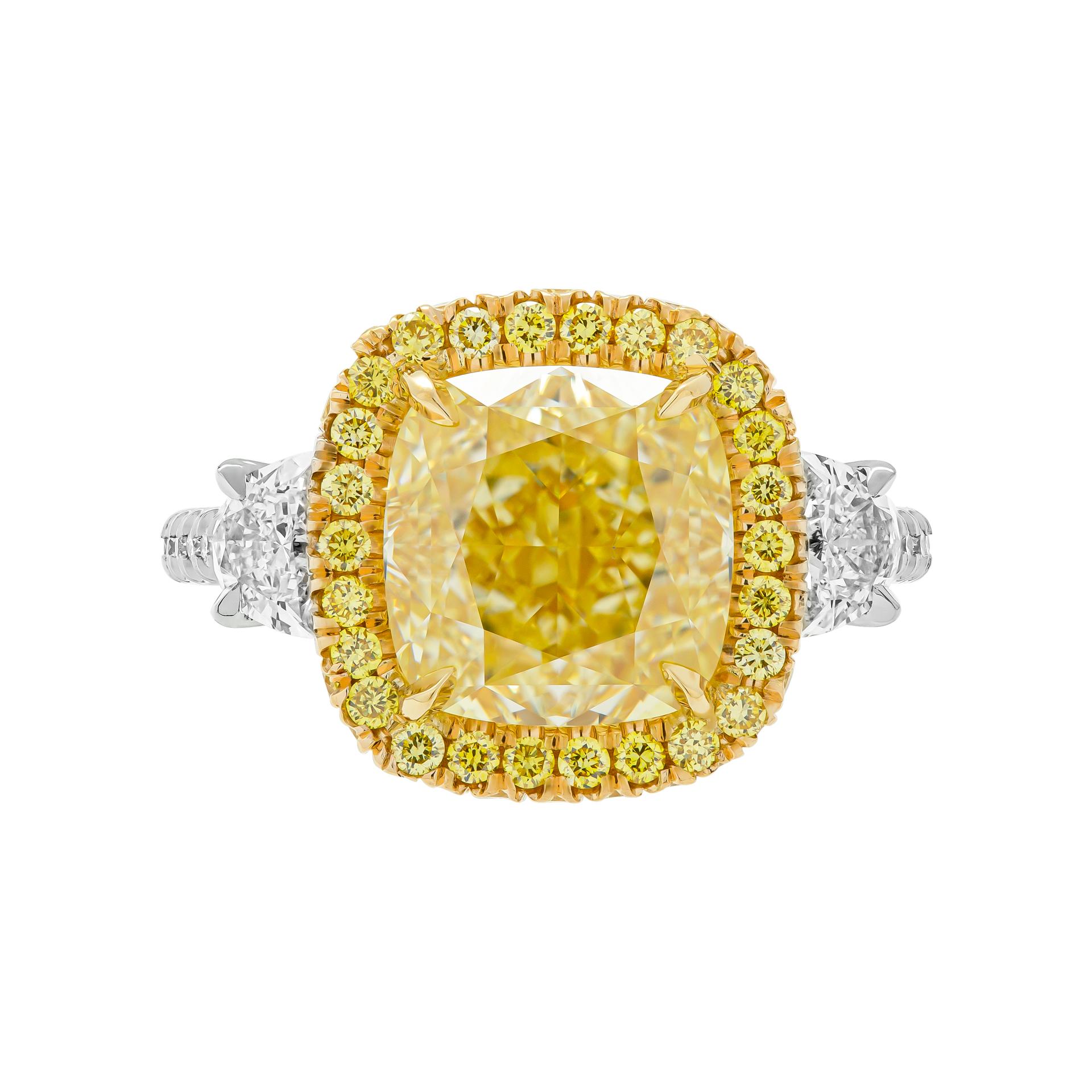Three stone ring in 18K Yellow Gold & Platinum 
Center stone: 4.51ct Fancy Yellow VS1 GIA#5222558510
Side stones: 0.53ct F-G VS halfmoons
Total Carat Weight of White stones: 0.18ct
Total Carat Weight of Yellow stones: 0.44ct
Total Carat Weight of