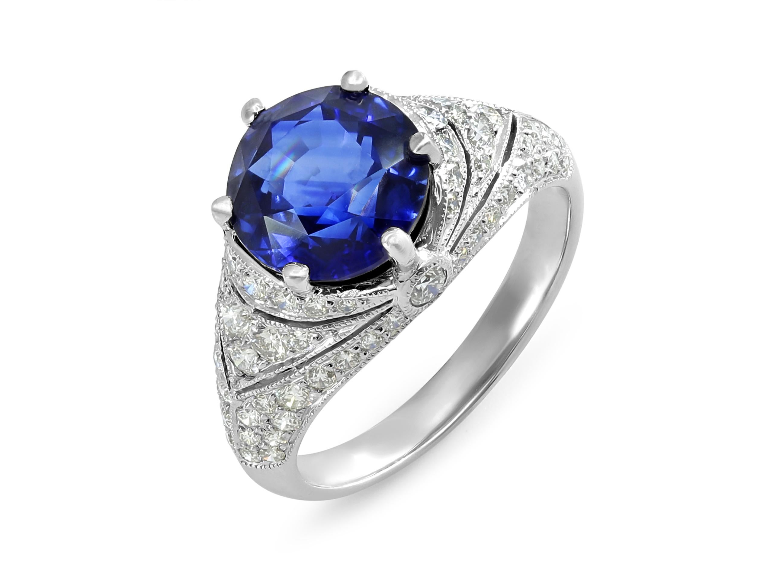 A platinum ring featuring a stunning 4.55-carat round sapphire of Sri Lankan origin, accompanied by a GIA Report (#2205449413) noting indications of heating. The sapphire is prong set with approximately 1.5 carats of round diamonds on the mounting. 