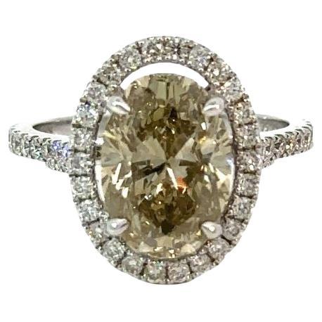 GIA Certified 4.56 Carat Brownish Greenish Yellow Oval Brilliant Diamond Ring For Sale