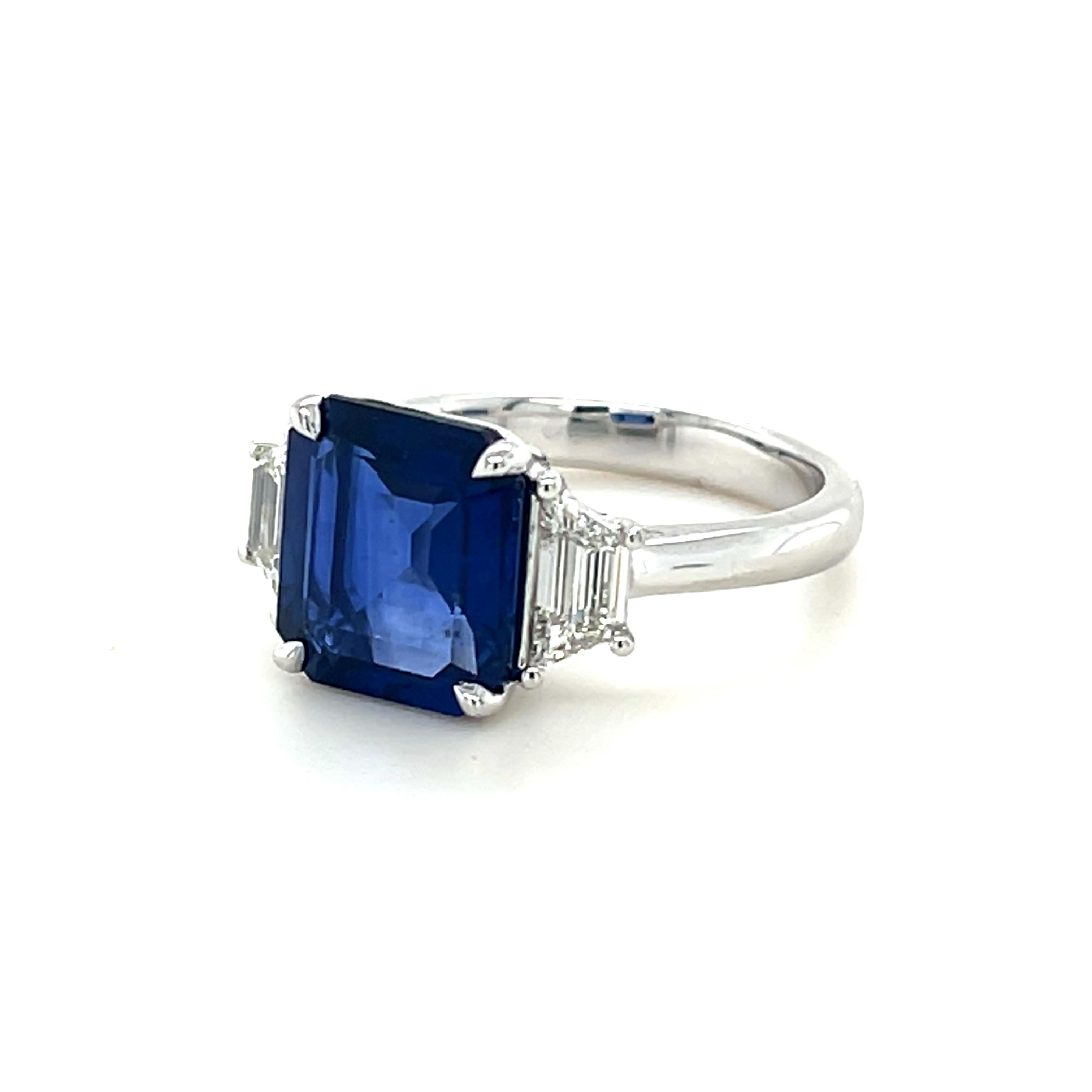 GIA certified emerald cut Ceylon Sapphire weighing 4.61 carats
Measuring (10.31x9.10x4.57) mm
Trapezoid diamonds weighing .76 carats
Diamond quality is G-VVS2
Set in platinum ring
7.16 grams