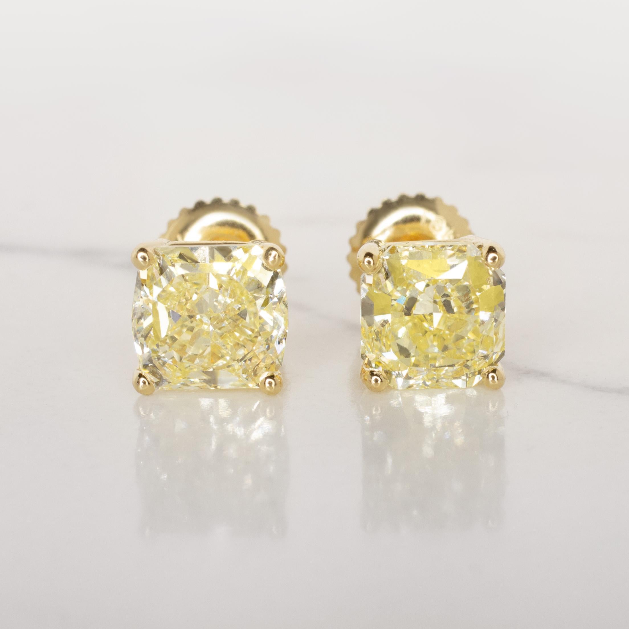 Elevate your elegance with this exceptional pair of GIA Certified Fancy Light Yellow cushion-cut diamond studs, each boasting a dazzling 6 carats. The captivating hue of these diamonds adds a touch of warmth and sophistication to any occasion.

Each