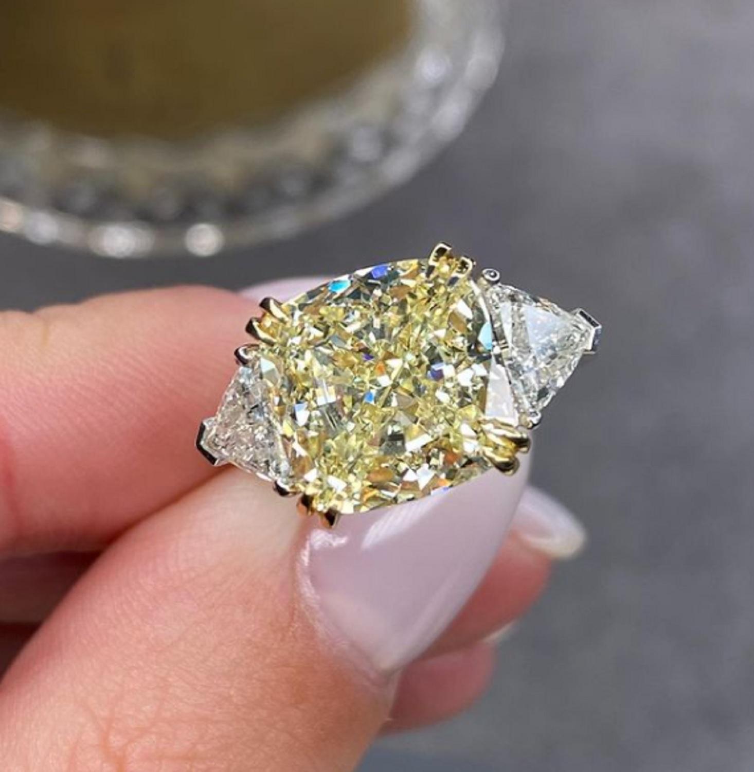 GIA Certified 4 Carat Fancy Light Yellow Cushion Three Stone Diamond Ring
The main stone is a 4 carat amazing fancy yellow diamond with great luster performance and tone!